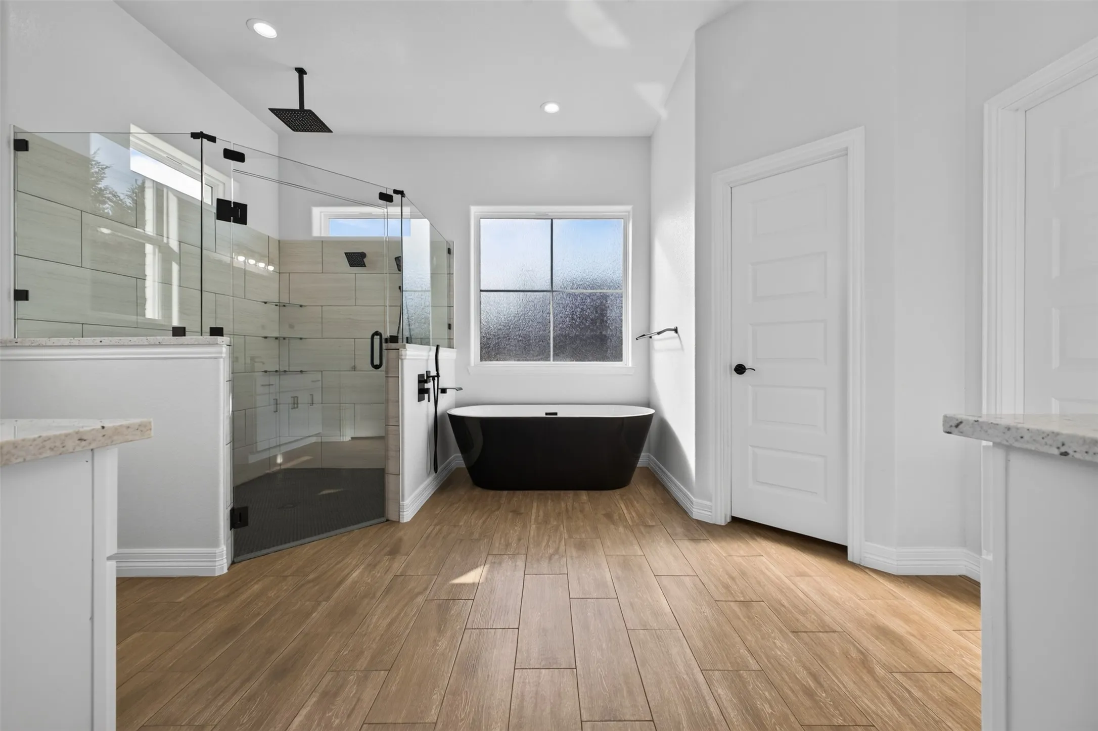 Spa inspired primary bath featuring a freestanding soaking tub, oversized walk-in shower, and spacious layout.