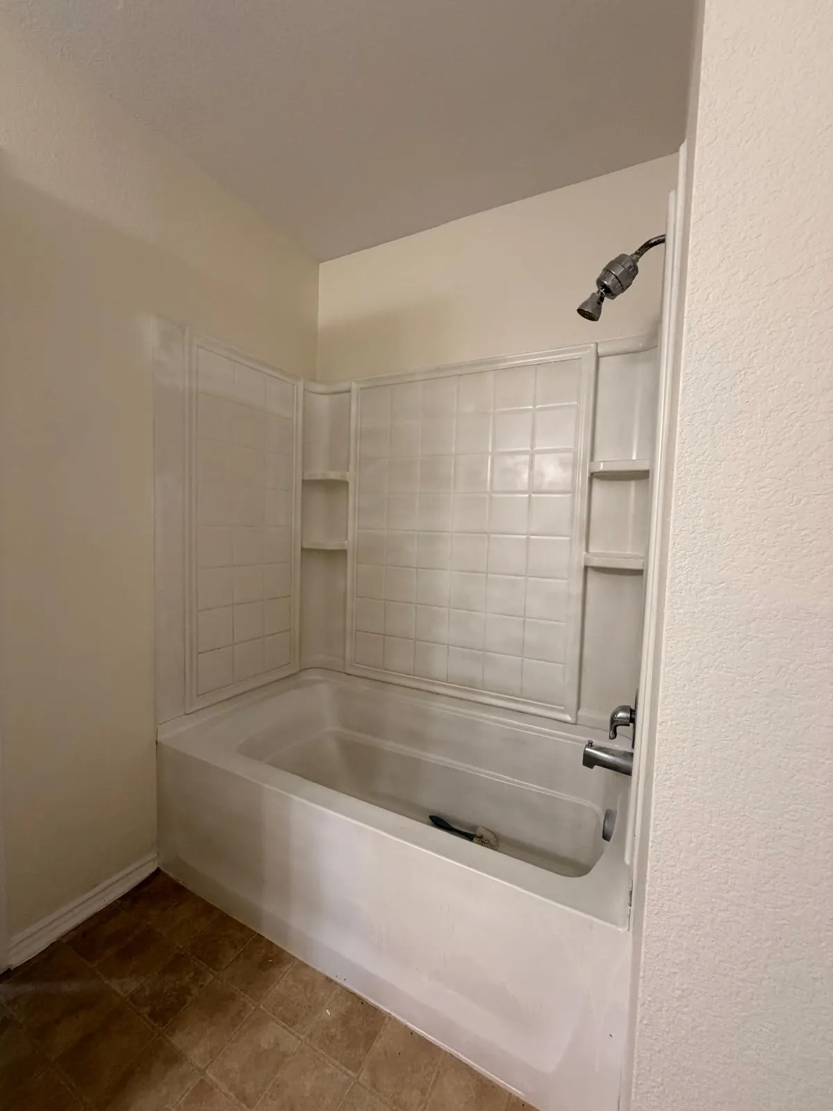 Tub and shower combination with white tile surround