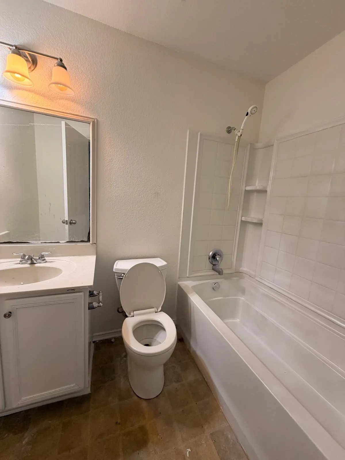 White single vanity with integrated sink, chrome faucet, and mirrored medicine cabinet
