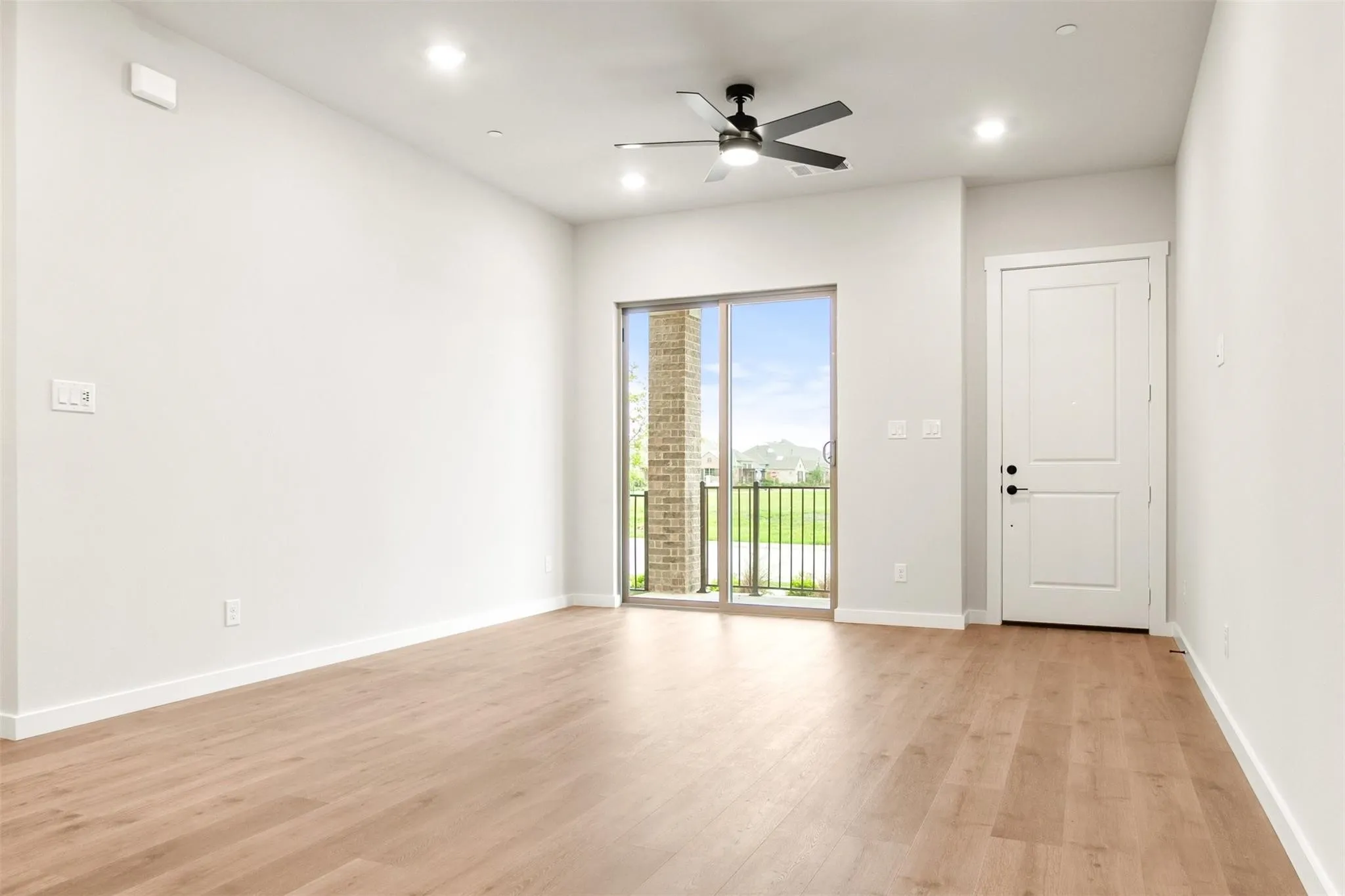Spare room featuring light wood-style flooring, a ceiling fan, and recessed lighting