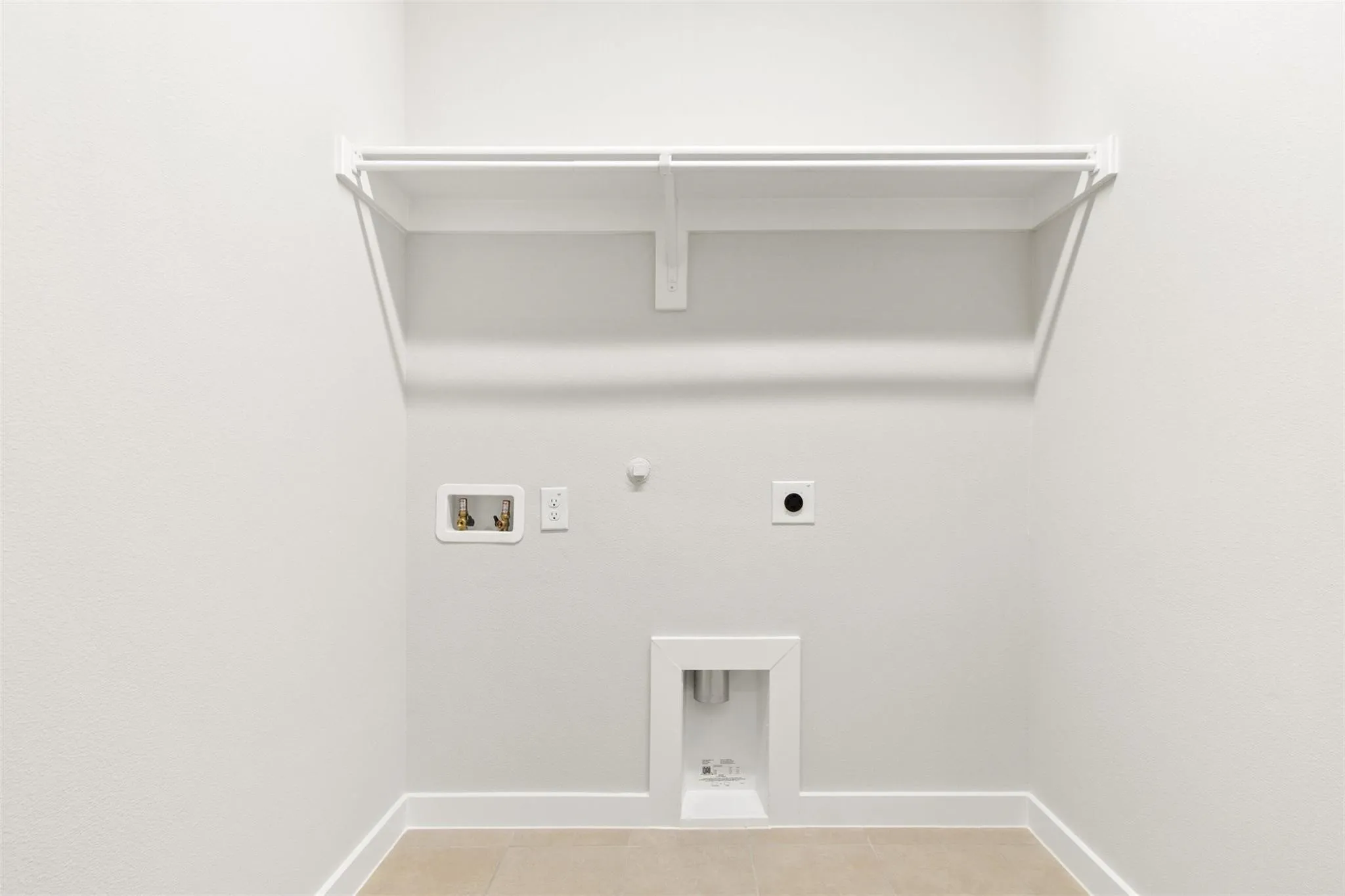 Laundry room featuring hookup for a gas dryer, hookup for an electric dryer, washer hookup, and light tile patterned flooring