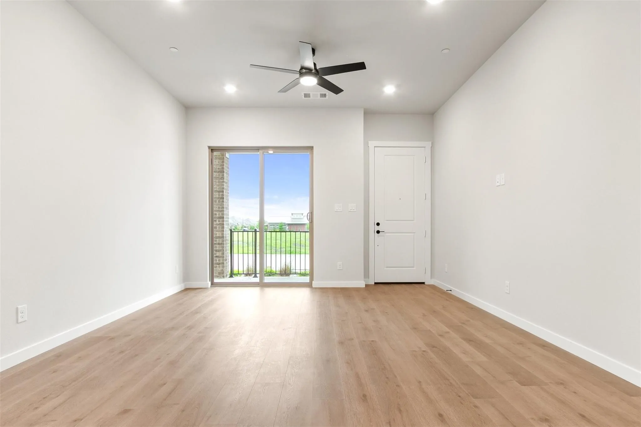 Unfurnished room with a ceiling fan, light wood finished floors, and recessed lighting