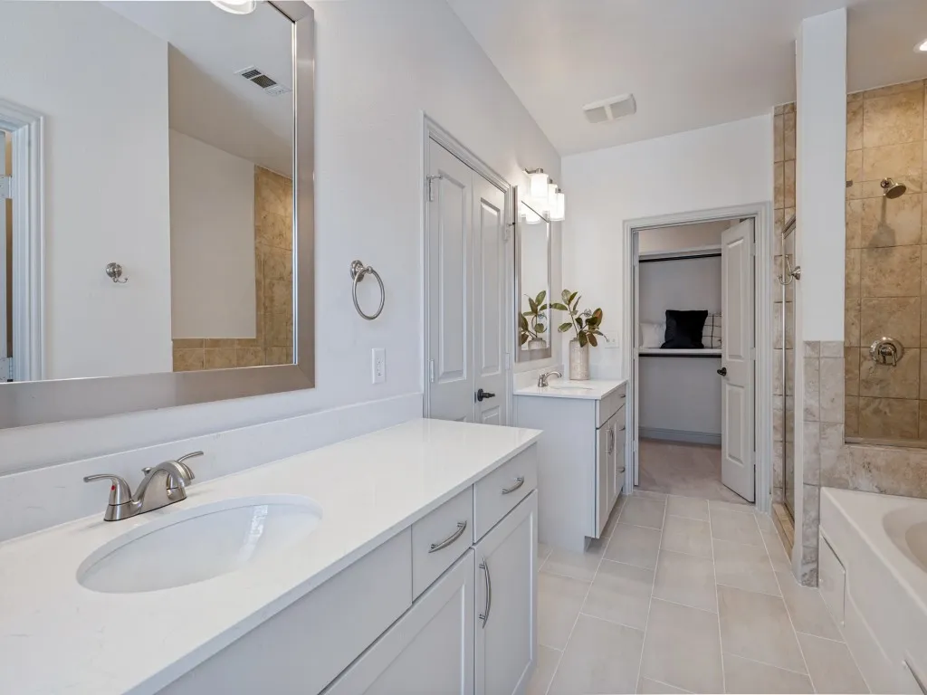 Primary bath with dual sinks & vanities. Walk-in closet.