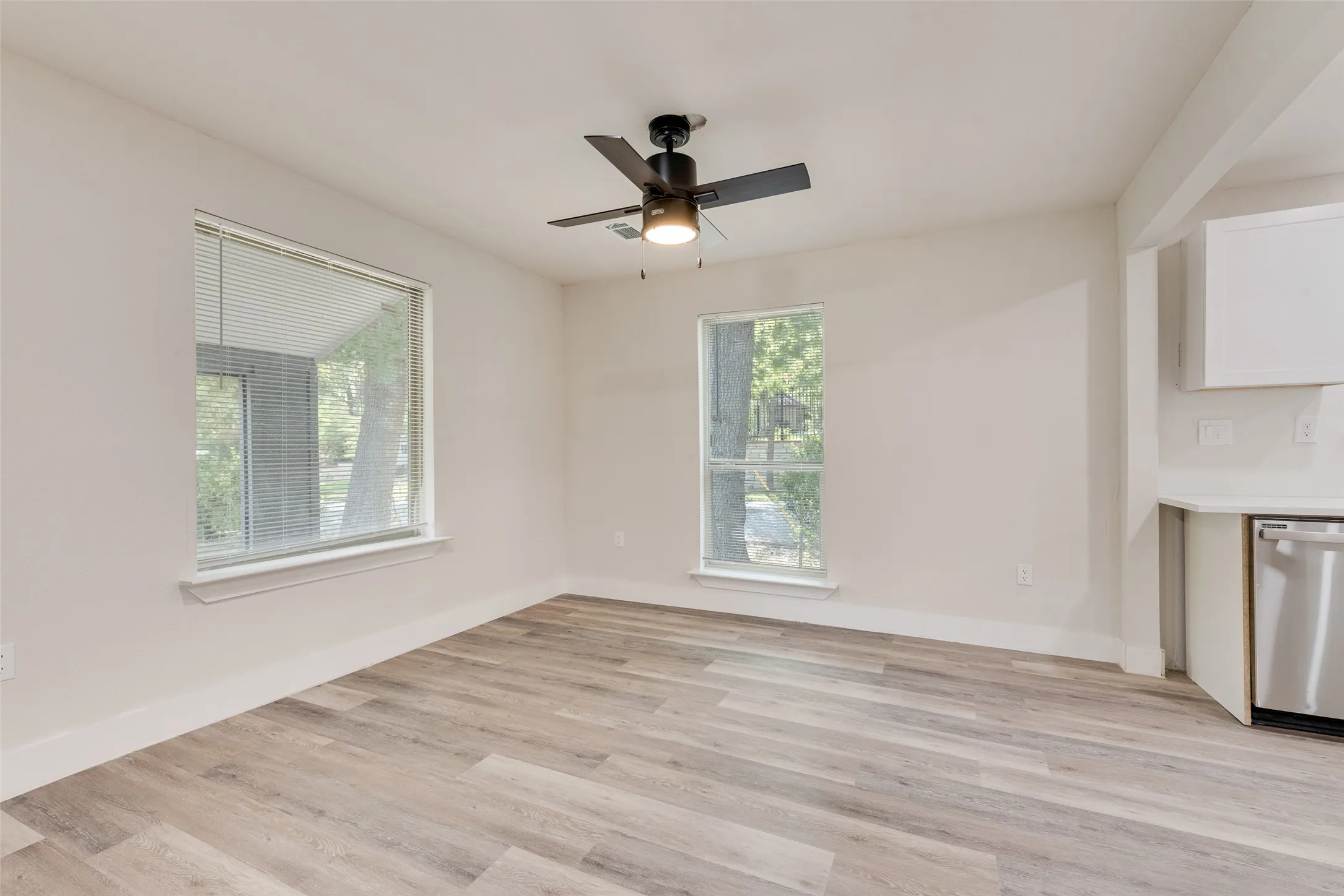 Recessed lighting, wood-finish flooring, and a ceiling fan