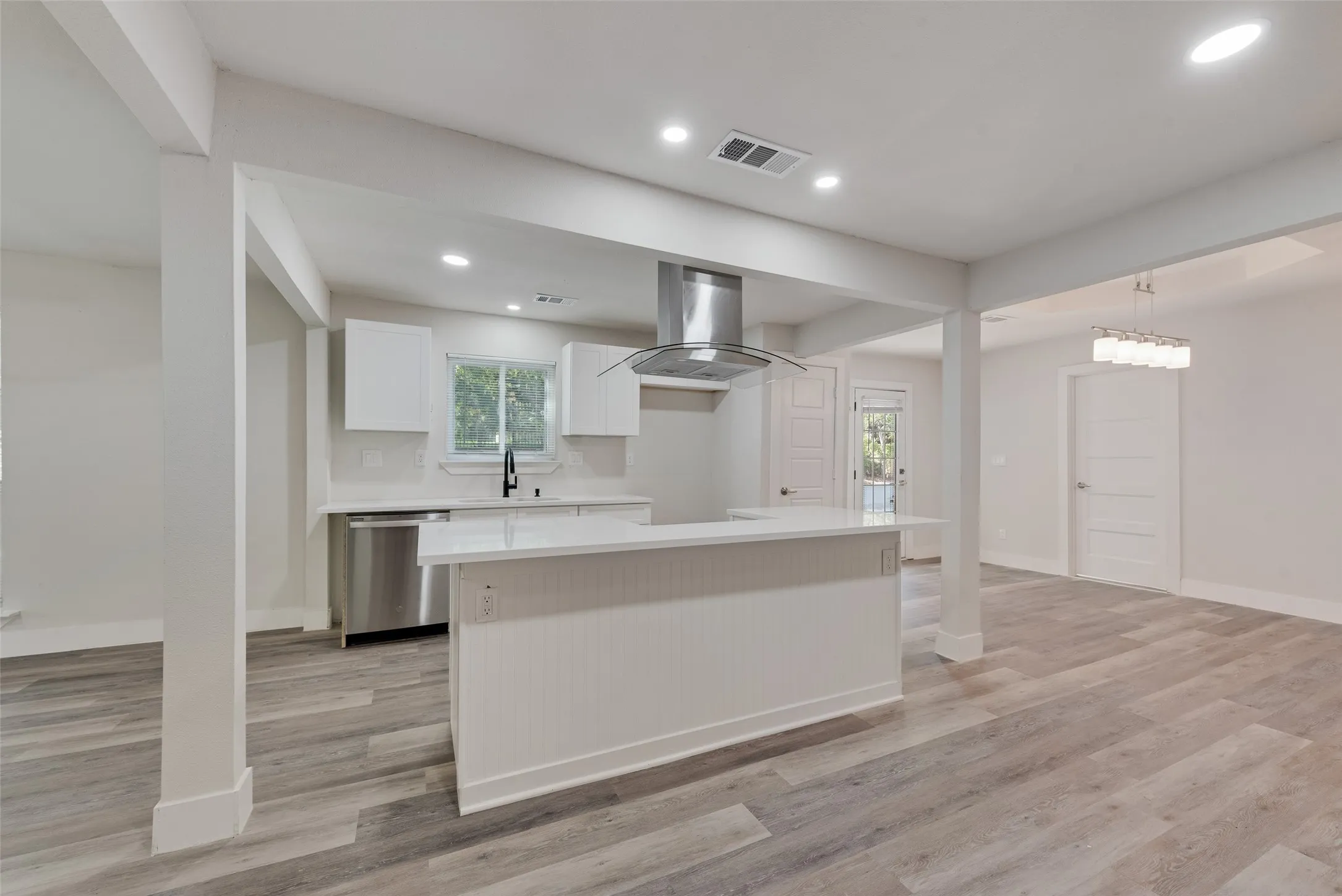 Kitchen featuring stainless steel appliances, white cabinetry, a central island, and recessed lighting