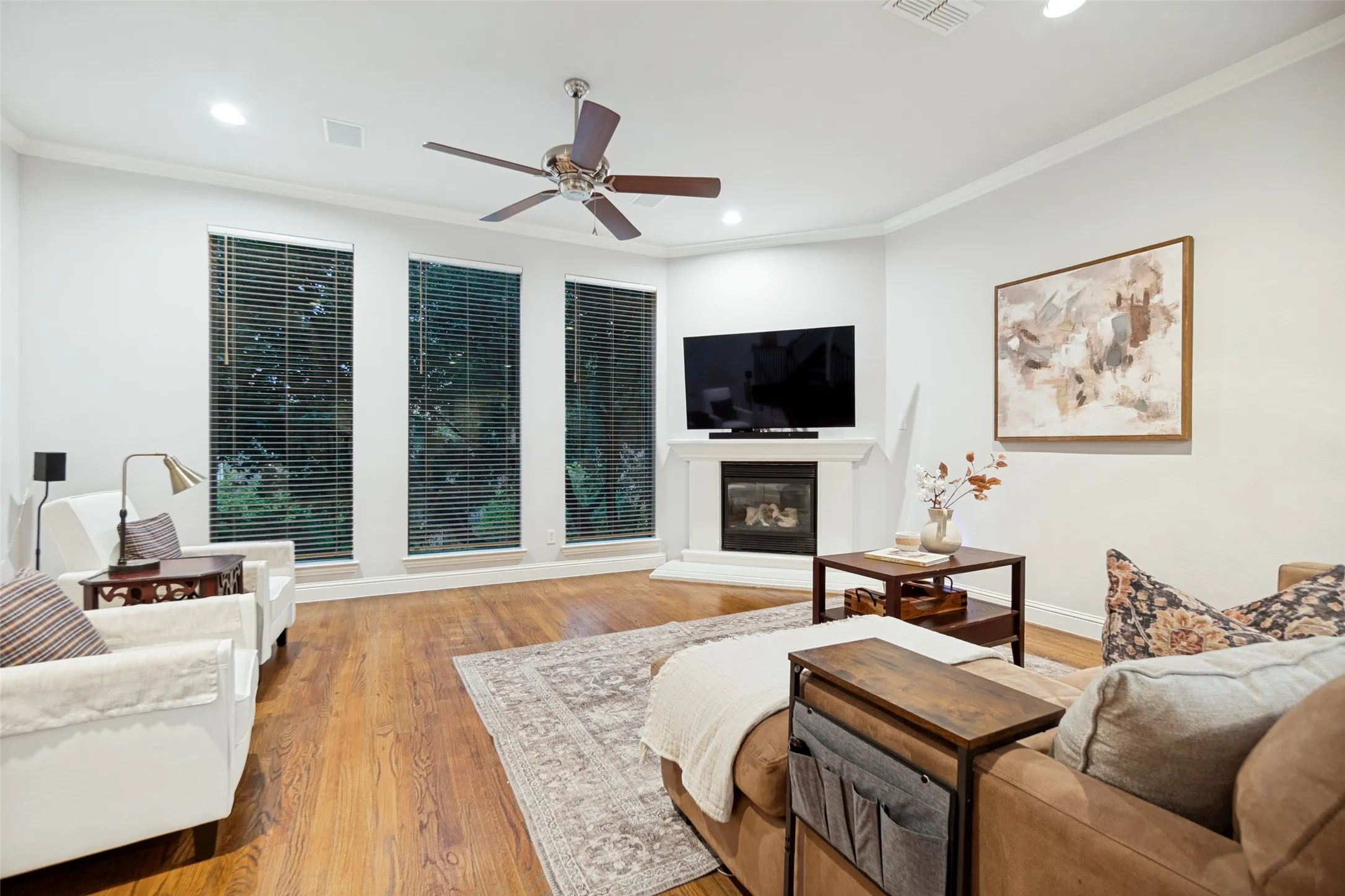 Floor to ceiling windows with hardwood floors and gas fireplace