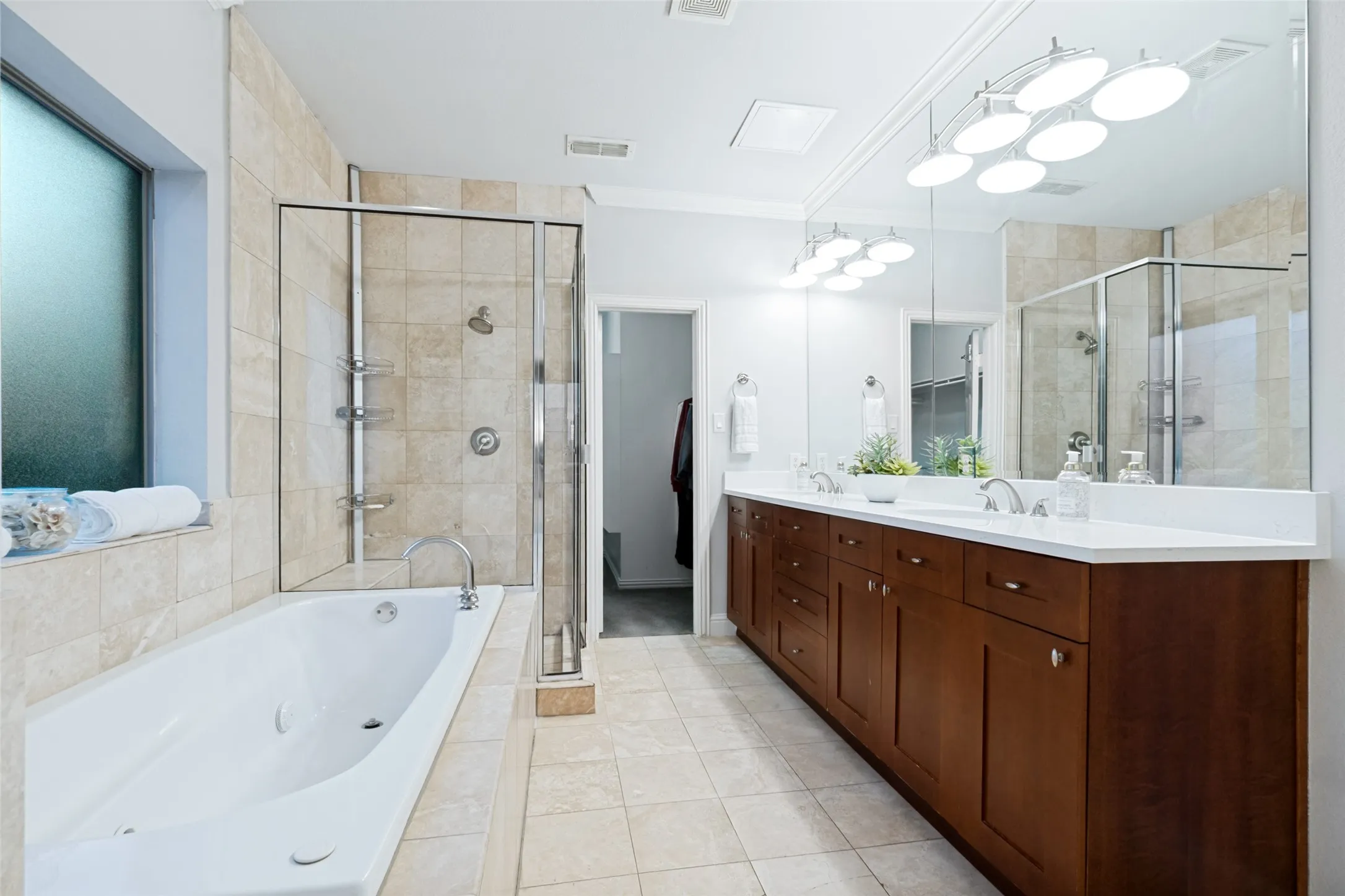 Jetted tub and separate shower to a walk in closet