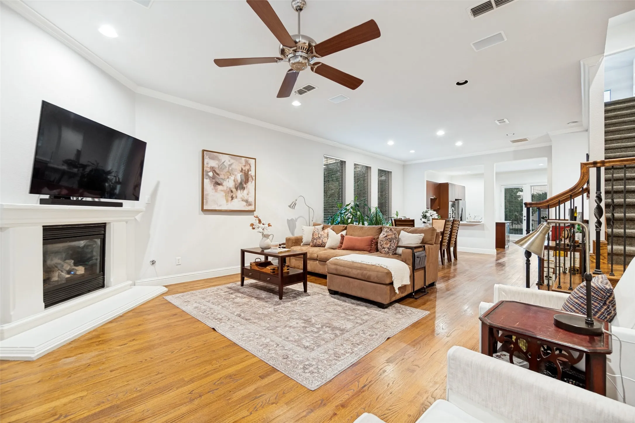 Living open to dining with crown molding and recessed can lights