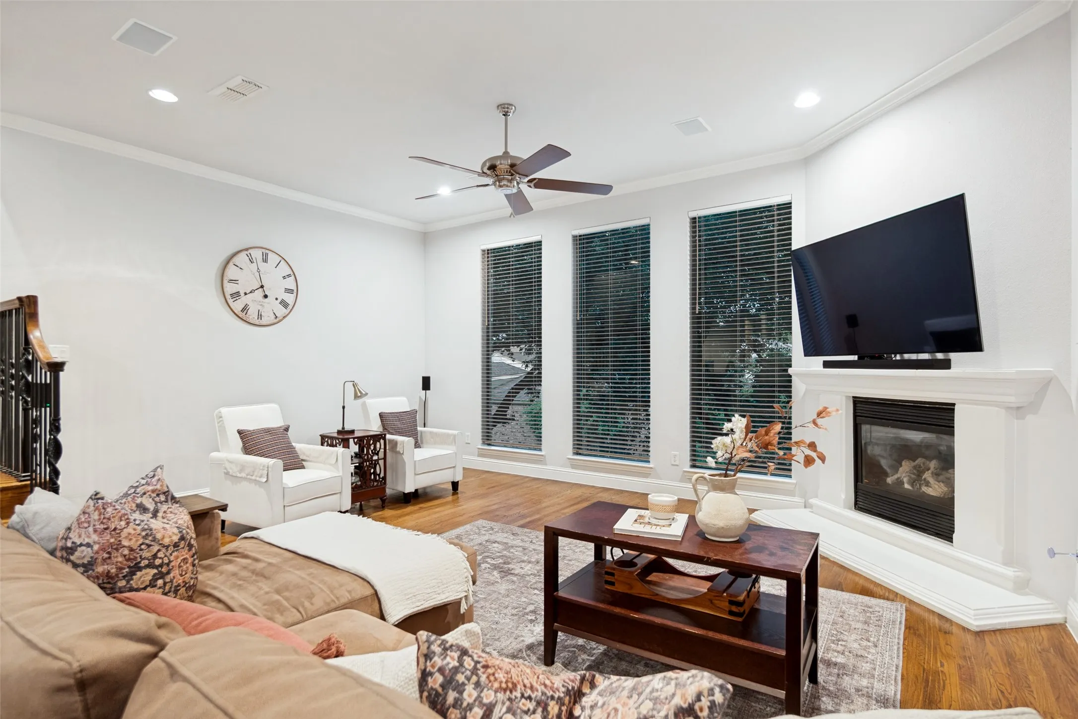 Living room with gorgeous hardwoods and floor to ceiling windows