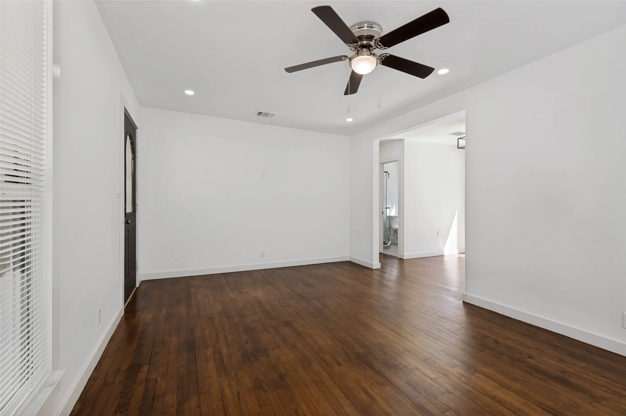 Hardwood flooring, recessed lighting, ceiling fan with light fixture, white walls, and white window blinds