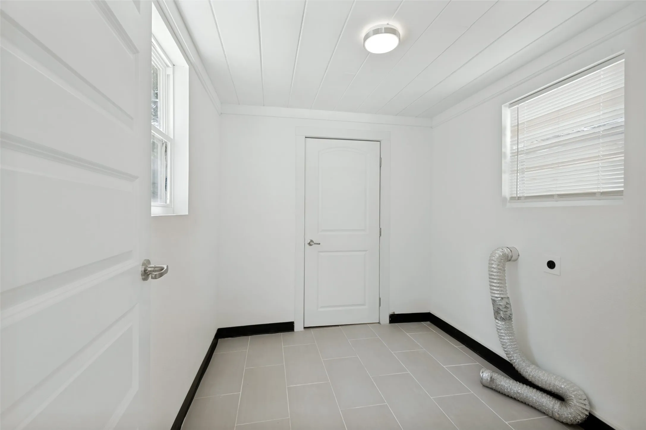 White paneled ceiling with a flush-mount light fixture
