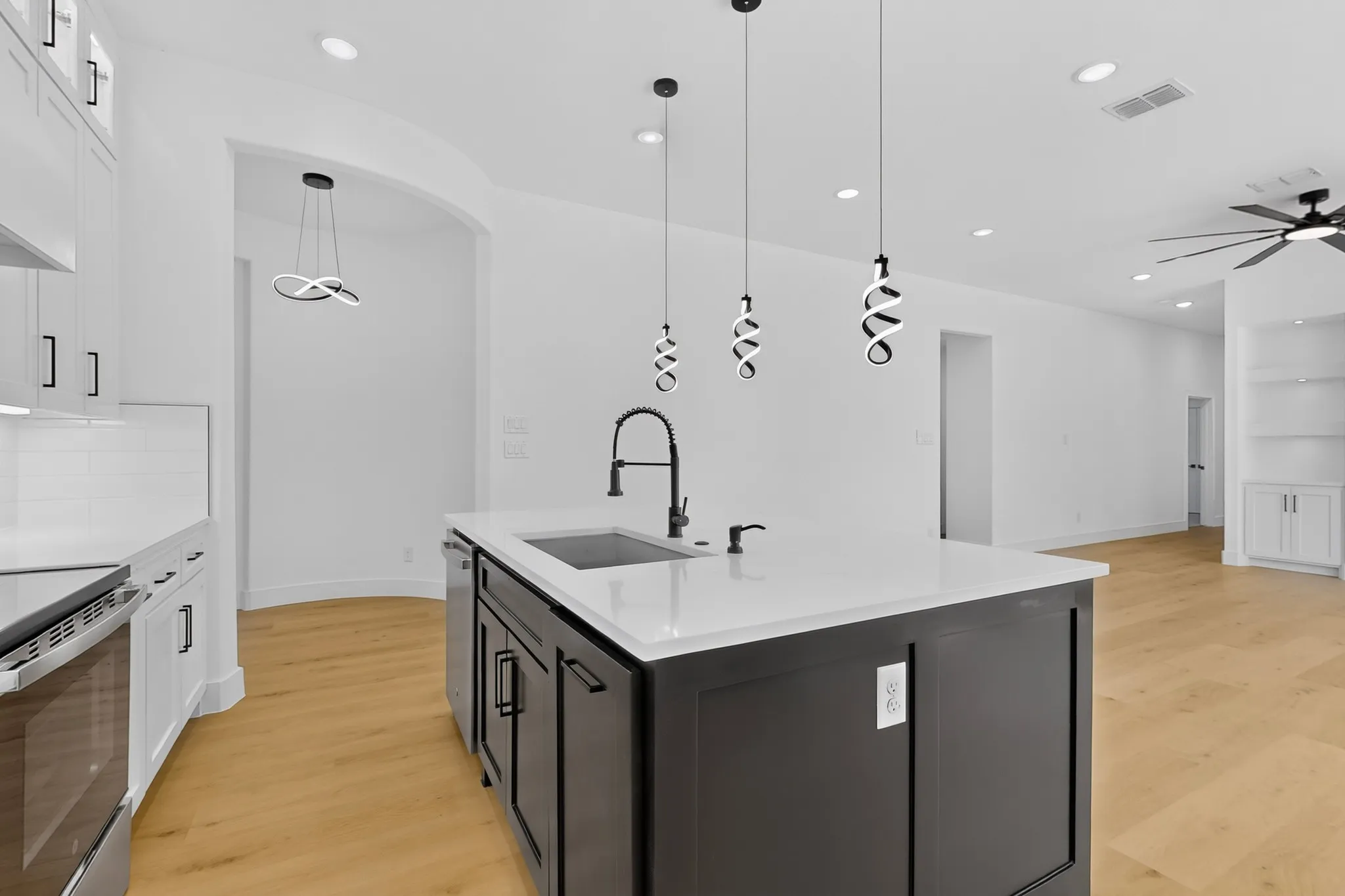 Kitchen island with sink overlooking the open living area