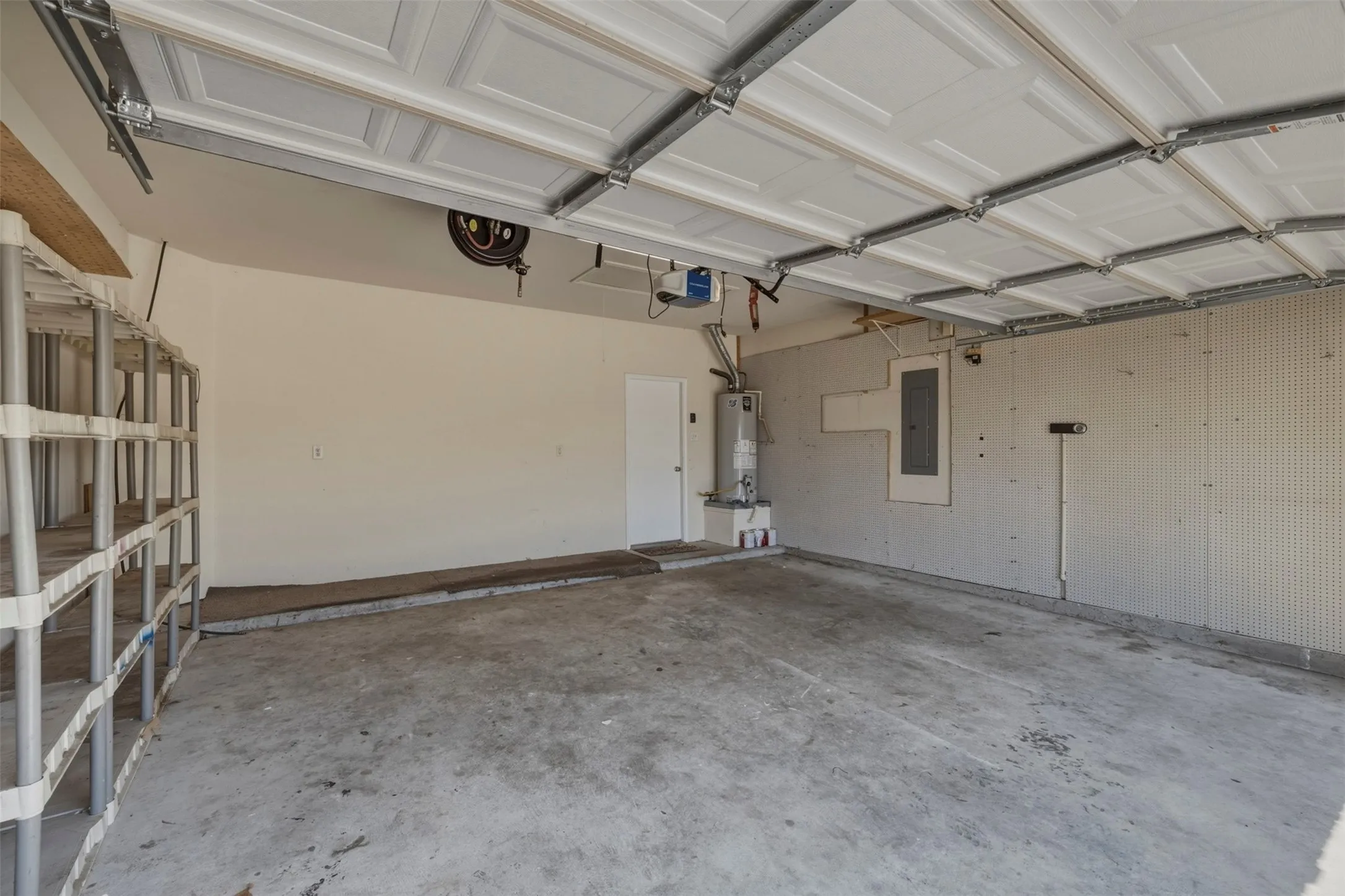 Spacious garage featuring concrete flooring and a paneled garage door