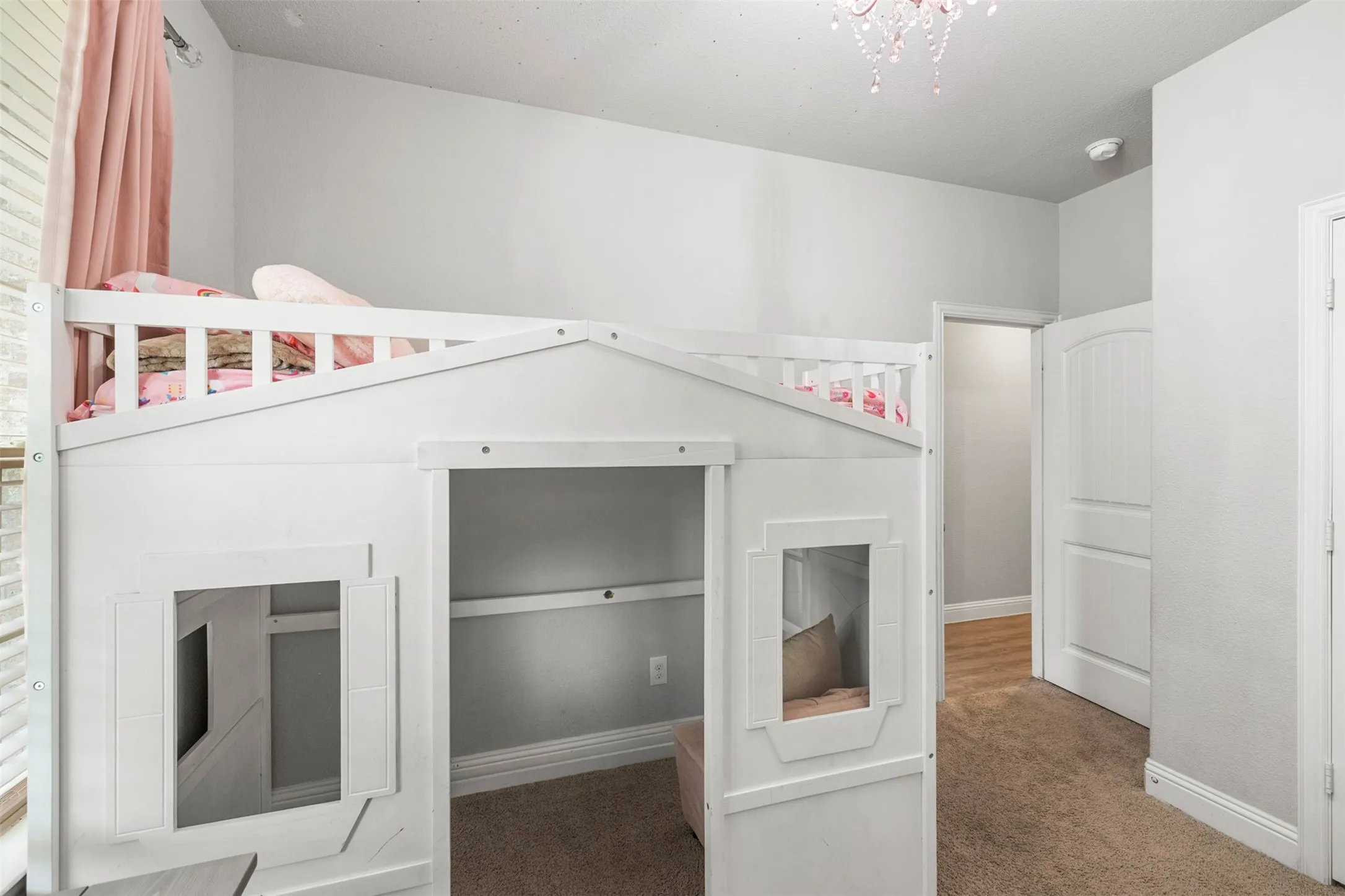 Plush carpeting and light gray wall paint create a neutral palette