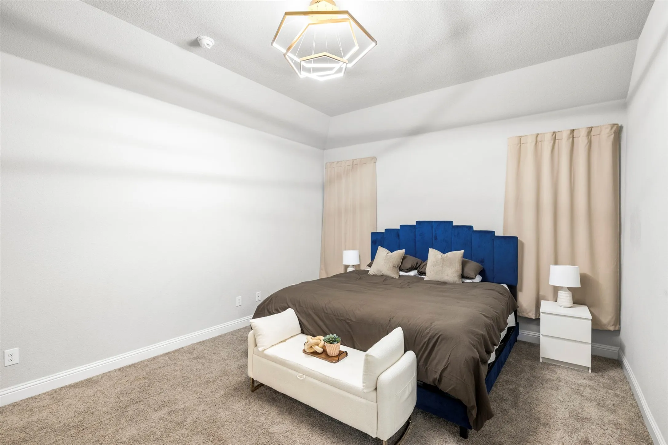 Vaulted ceiling with a geometric flush-mount light fixture