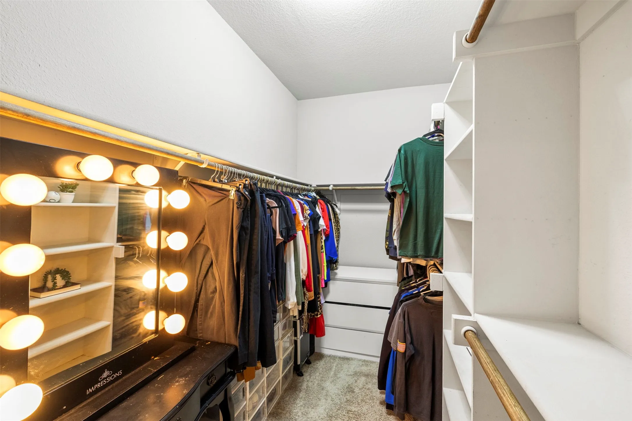 Walk-in closet featuring built-in shelving, hanging rods, and wood-finish flooring