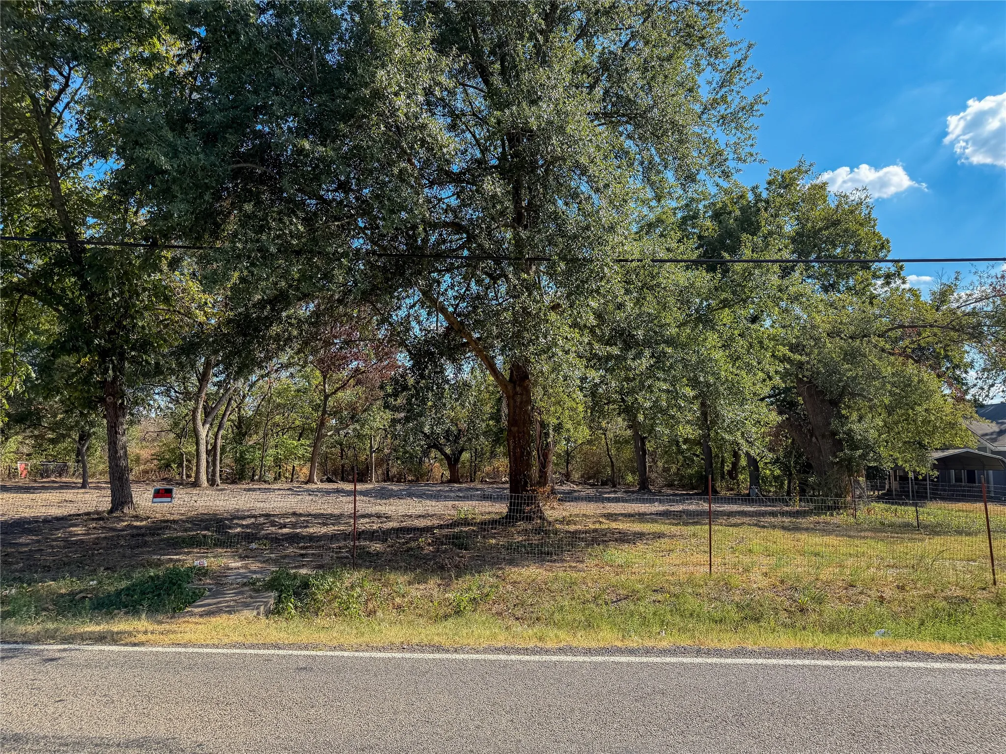 Expansive lot featuring mature trees and a clear building site