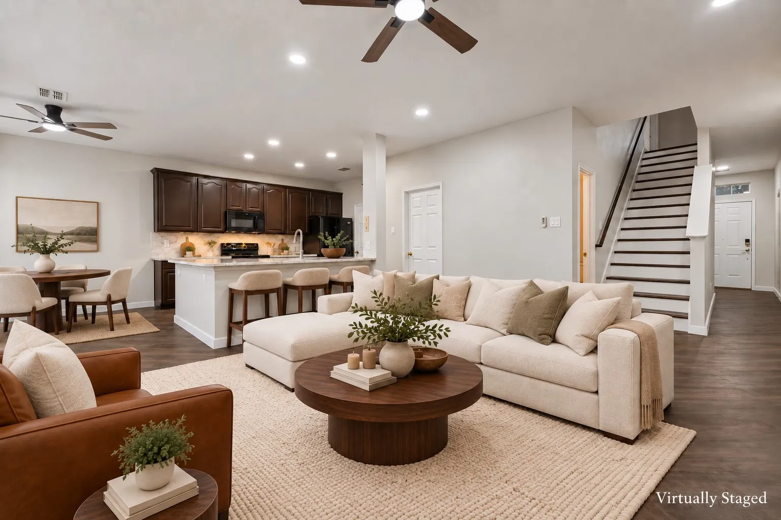 Open-concept living space featuring wood-finish flooring, recessed lighting, and ceiling fans