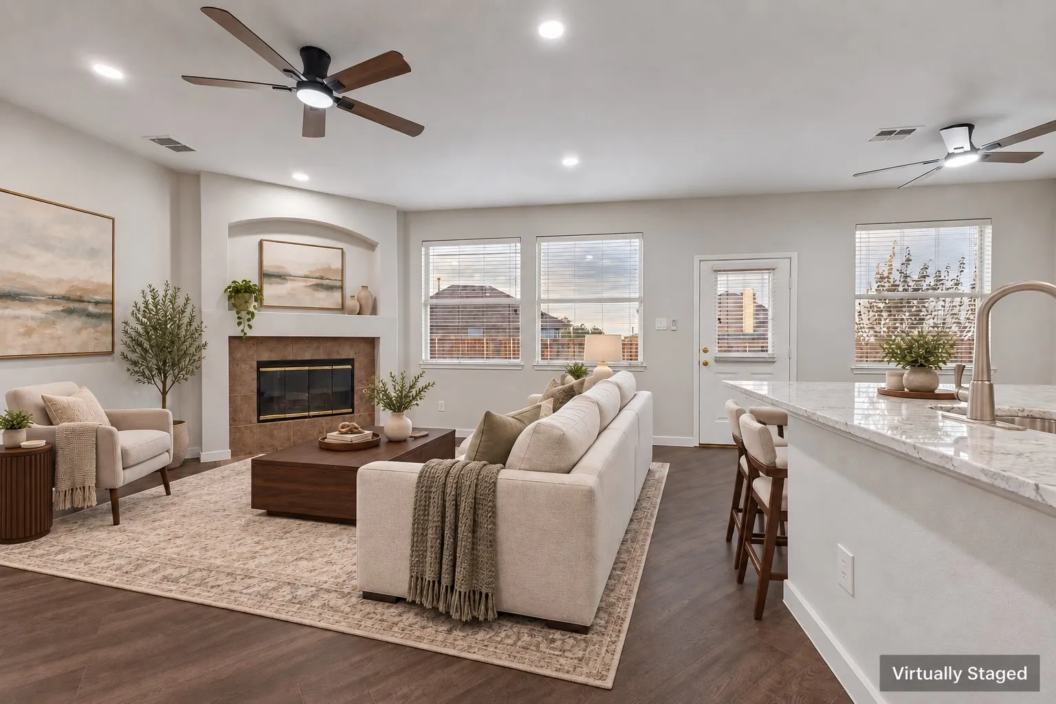 Spacious living area featuring wood-finish flooring, recessed lighting, and ceiling fans