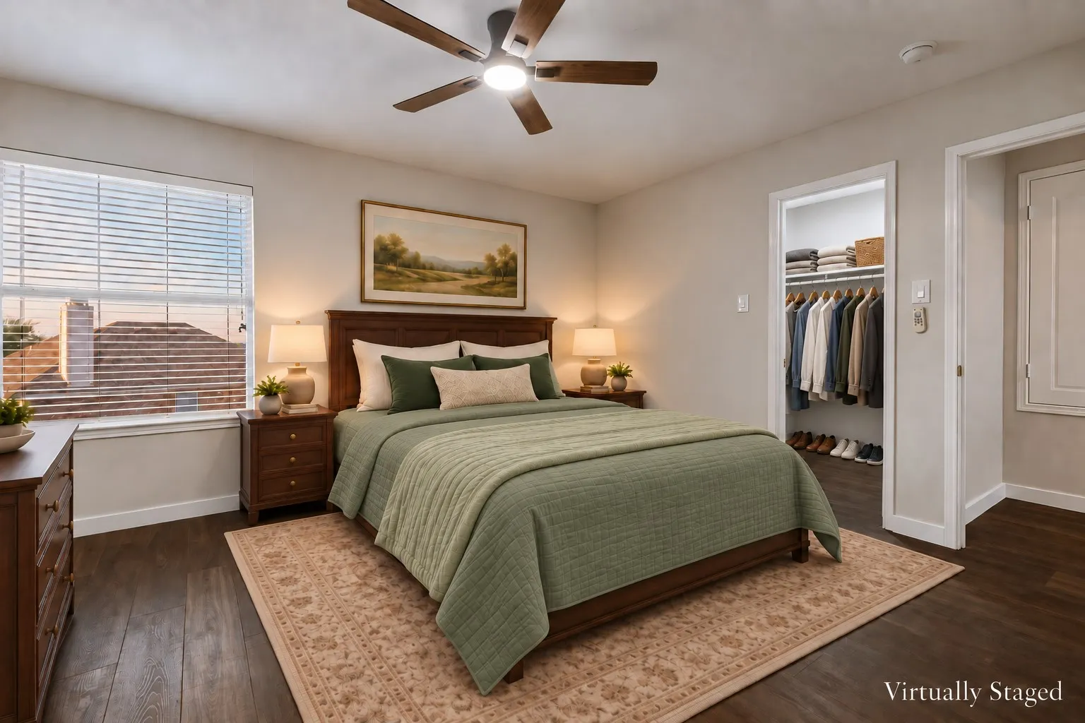 Wood-finish flooring, ceiling fan with integrated lighting, window with blinds, and a built-in closet with shelving and hanging space