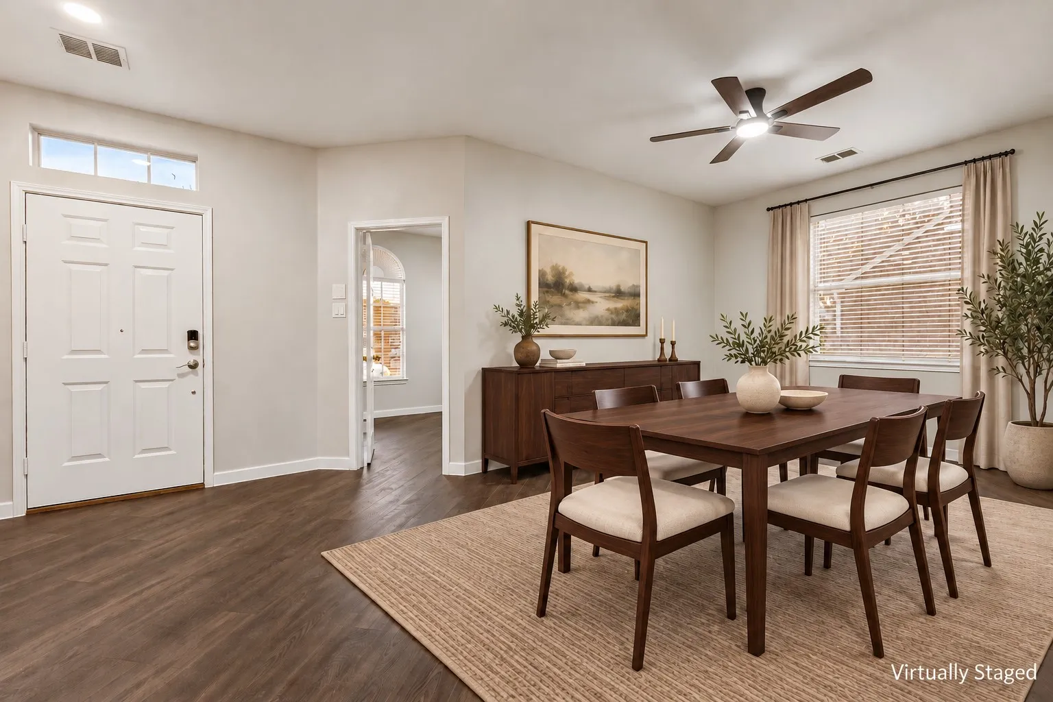 Wood-finish flooring, white paneled entry door, transom window, recessed lighting, and a ceiling fan with integrated lighting