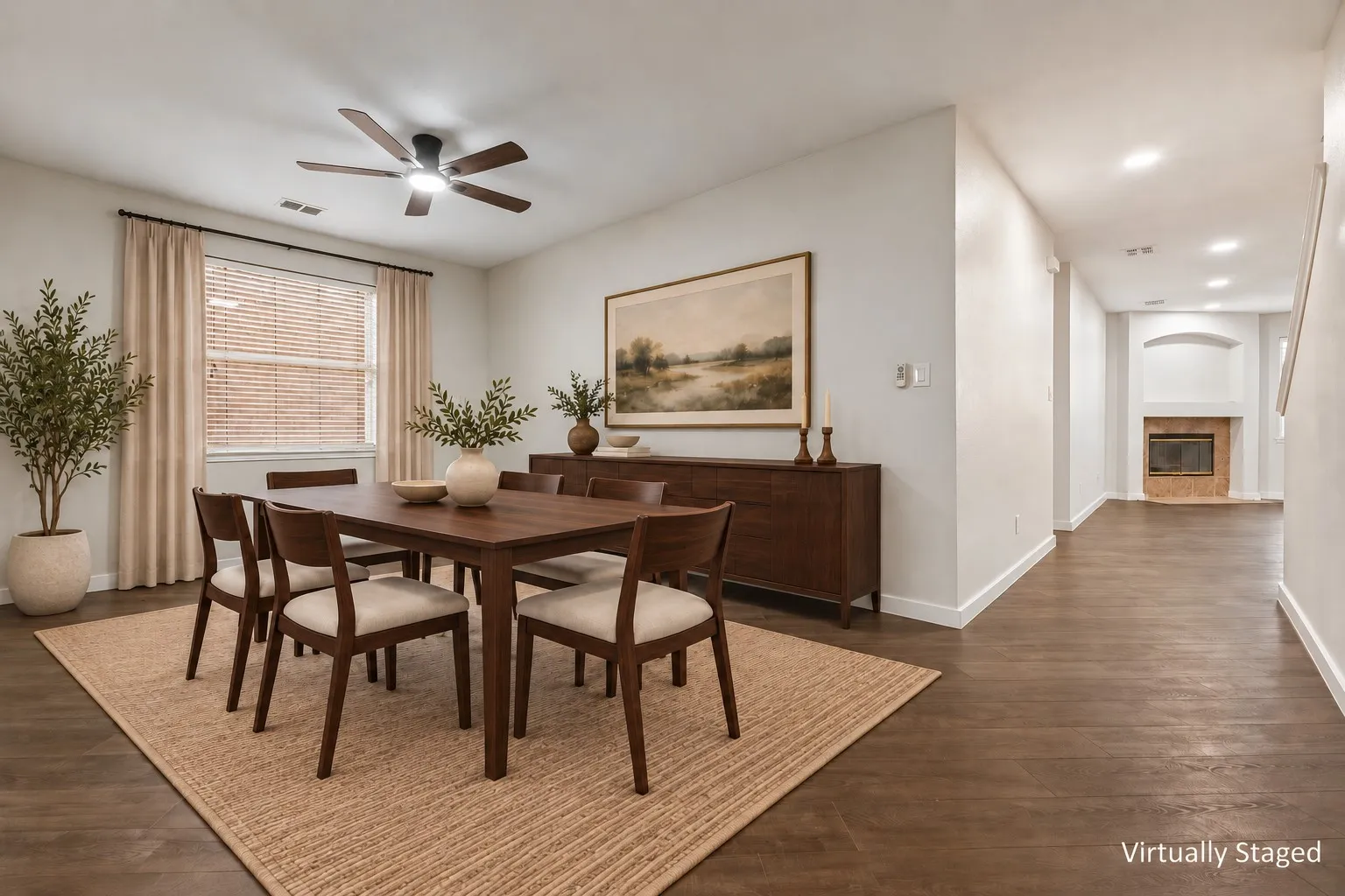 Spacious dining area featuring wood-finish flooring, a ceiling fan, and window with blinds