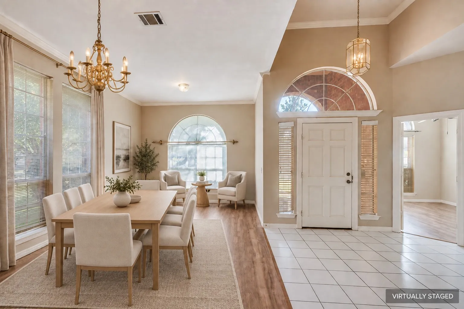Formal entry with high ceilings, an arched transom window, and tiled flooring