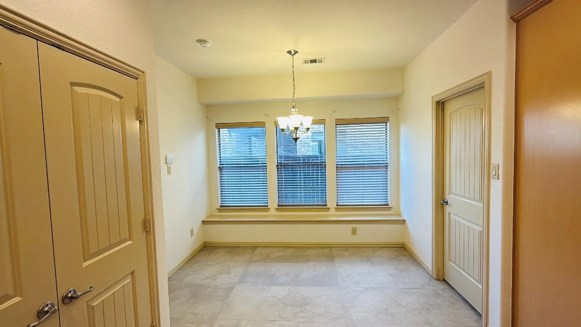 Recessed lighting, tiled flooring, and multiple windows with blinds