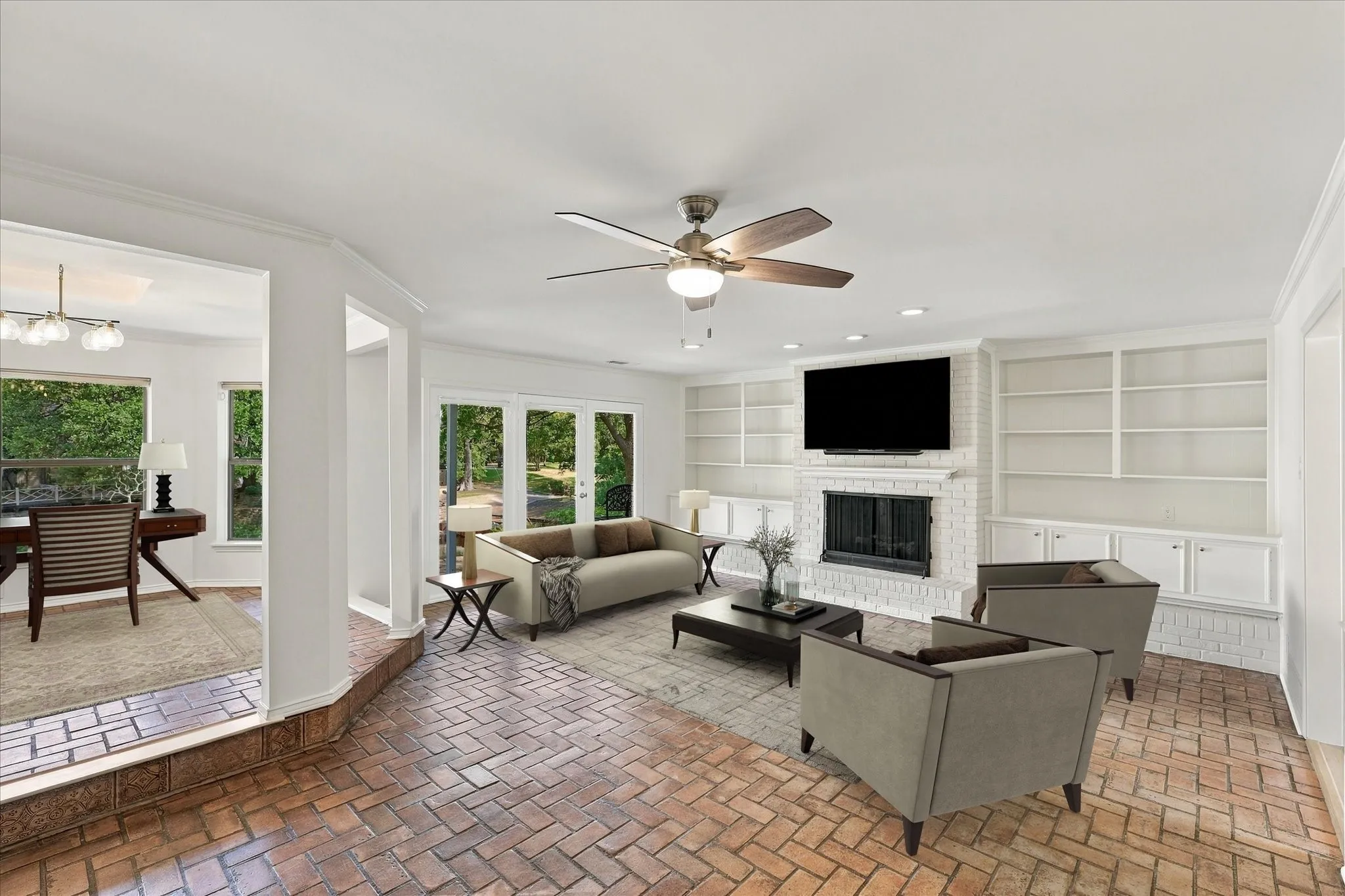 Herringbone brick flooring, white brick fireplace, built-in shelving, recessed lighting, and multiple paneled glass doors