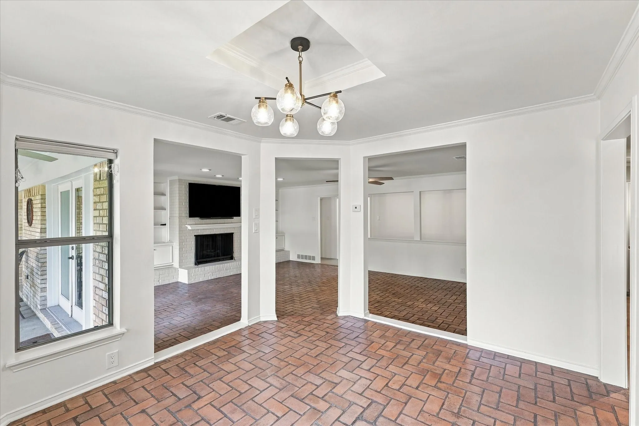 Brick-pattern flooring with a modern multi-bulb chandelier