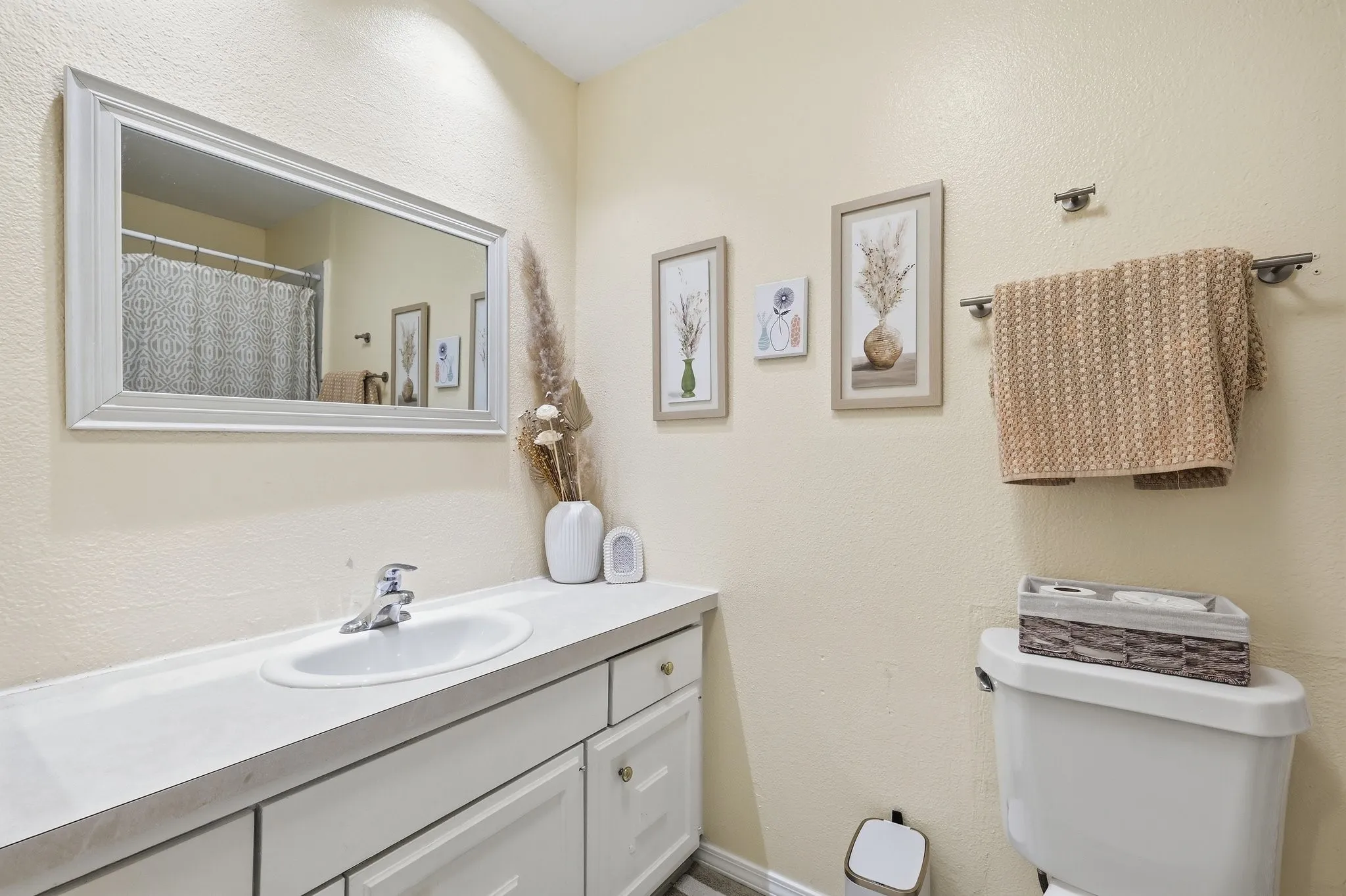 Vanity with integrated sink, chrome faucet, framed mirror, and built-in storage cabinetry