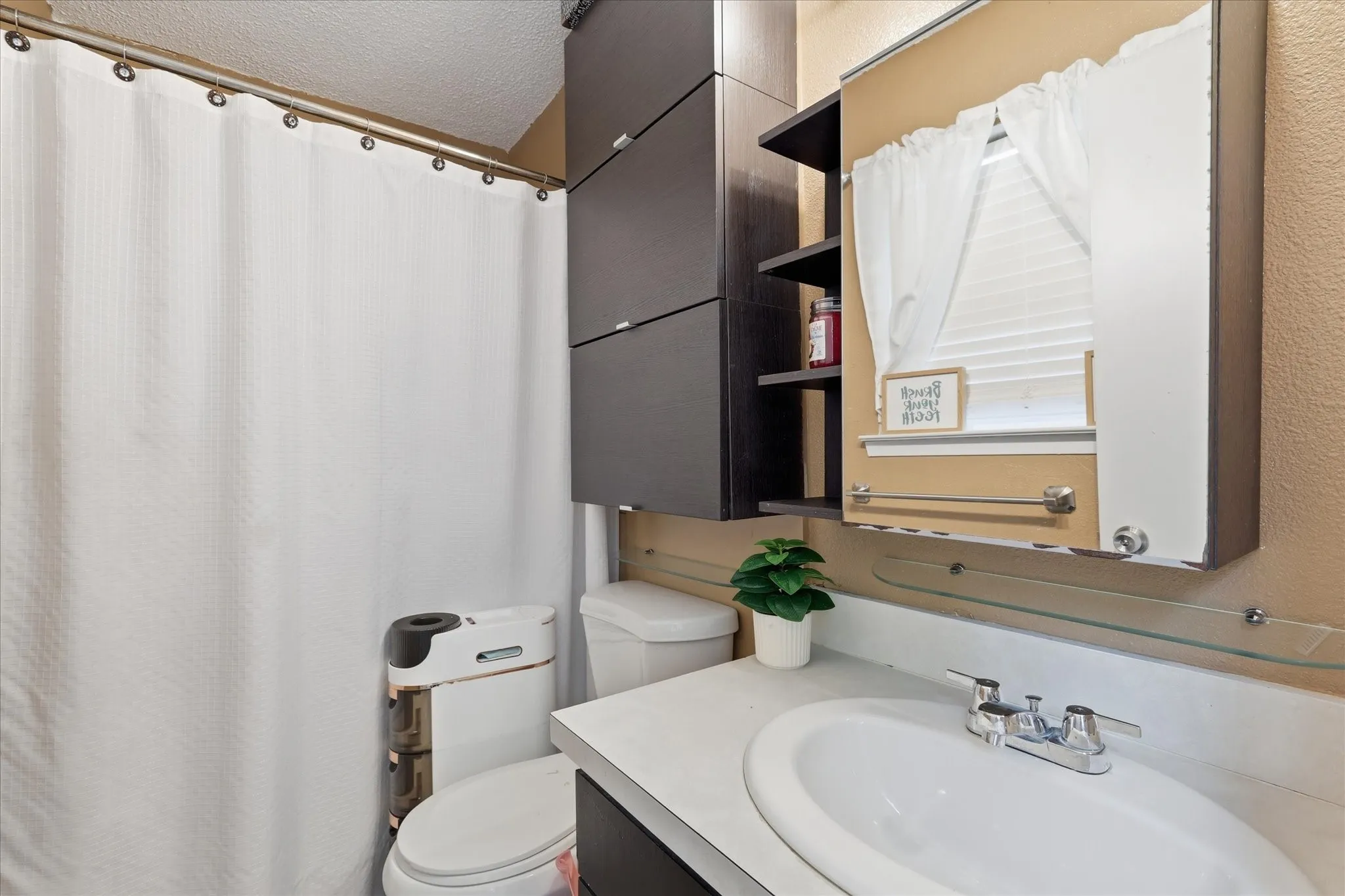 Bathroom featuring a white drop-in sink, chrome-finish faucet, and a large wall-mounted medicine cabinet with an integrated mirror