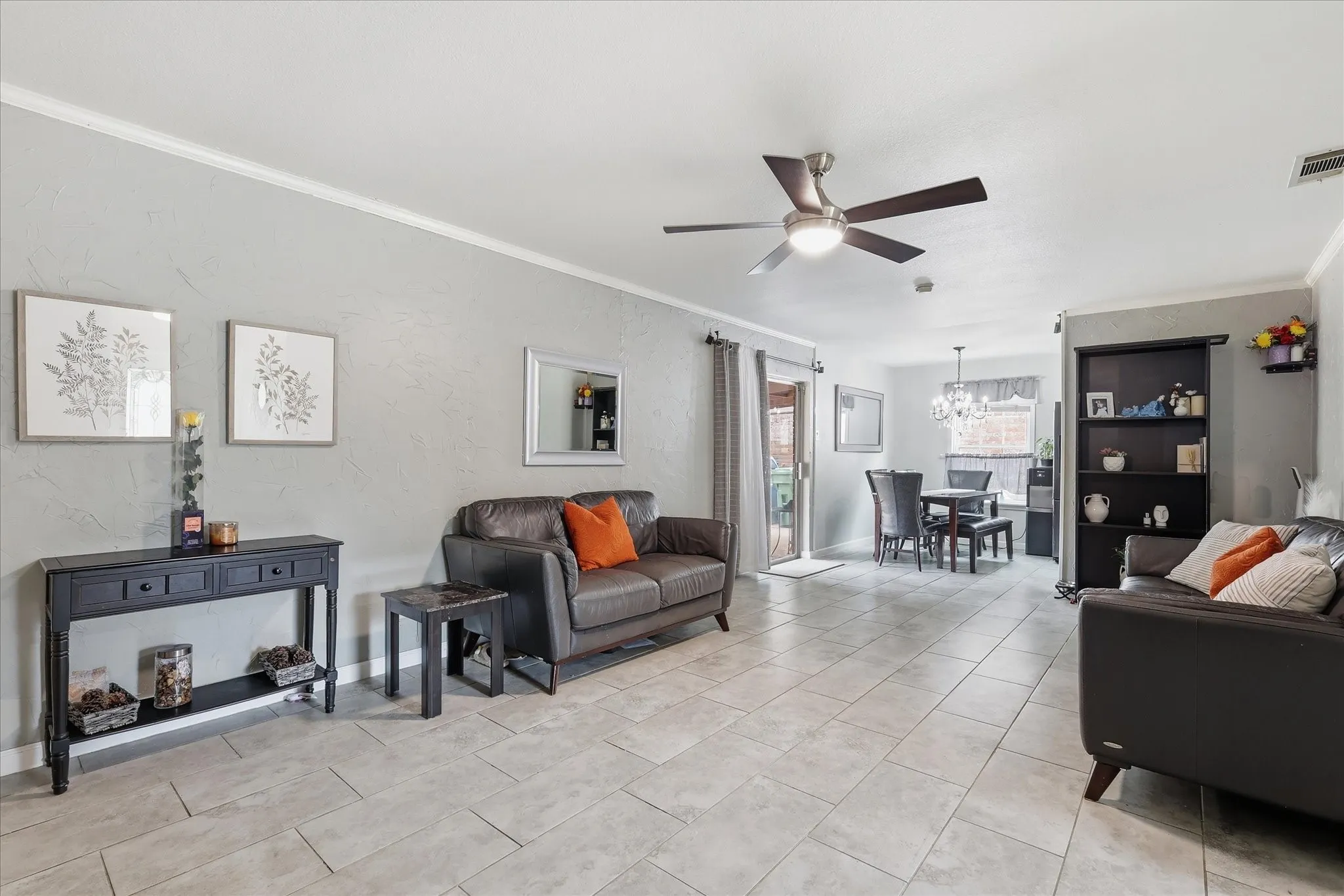 Neutral-toned tile flooring, recessed lighting, and a ceiling fan with integrated lighting