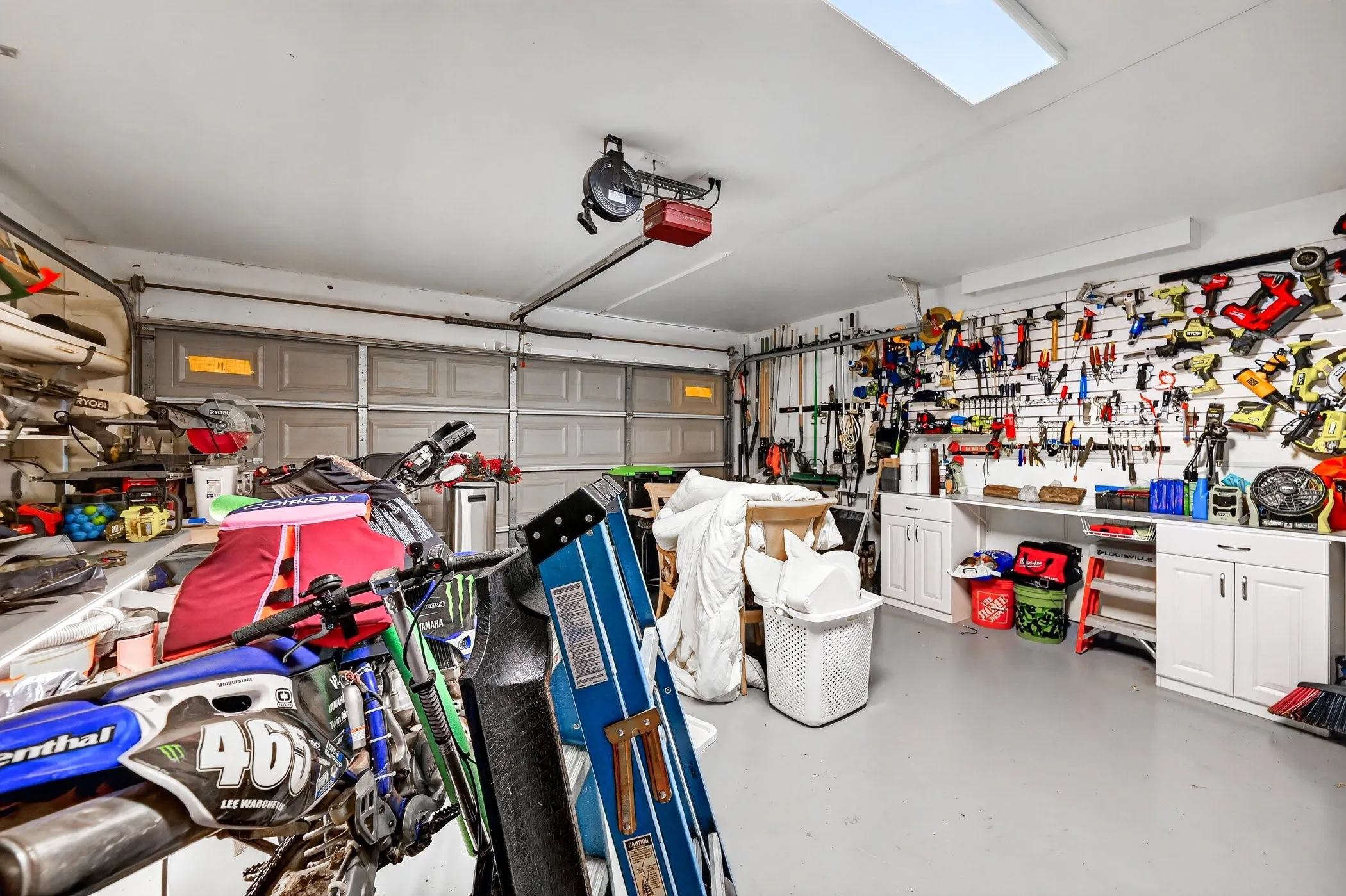 Garage showing epoxy floors & tool slat hanger.