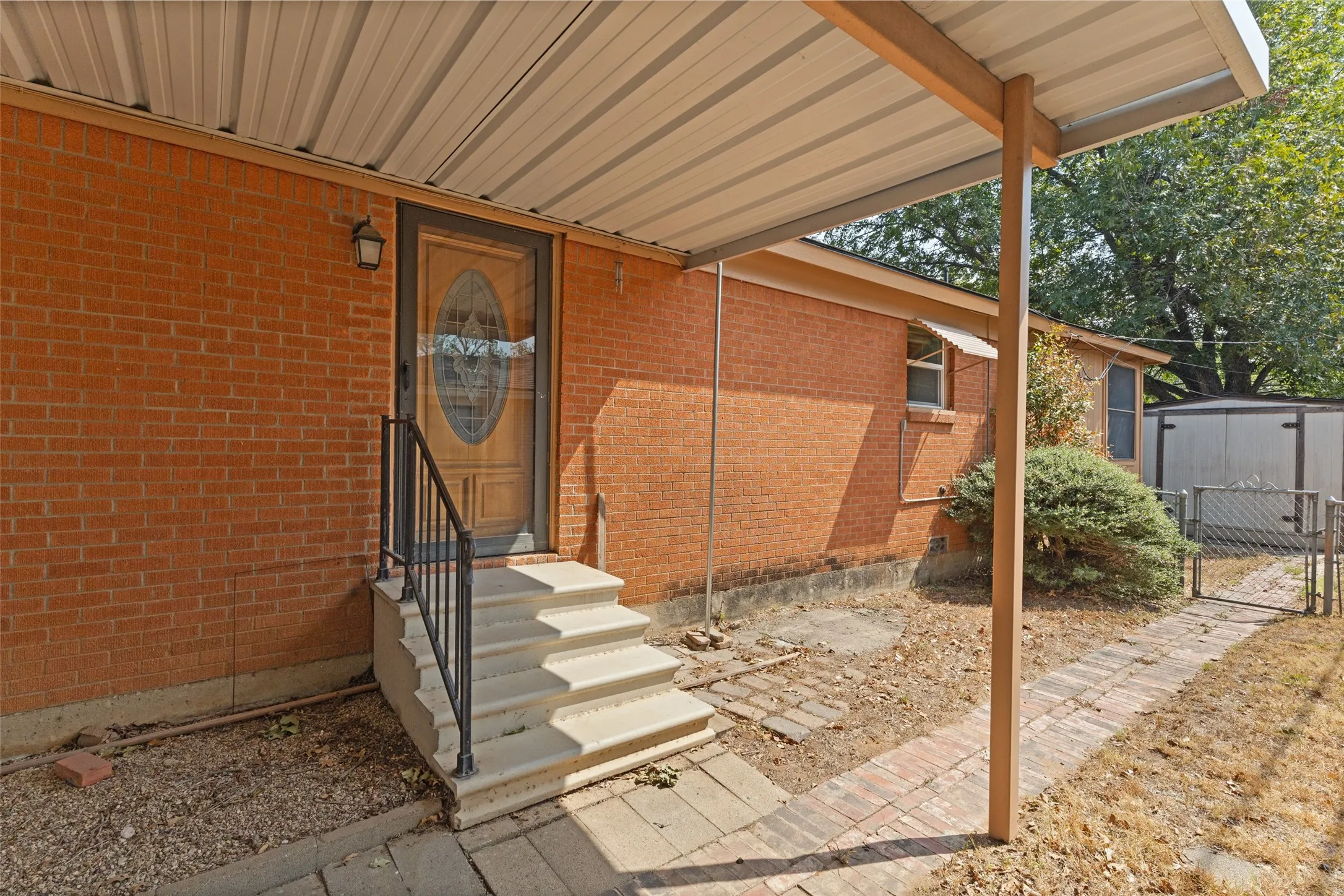 Red brick exterior with a covered porch