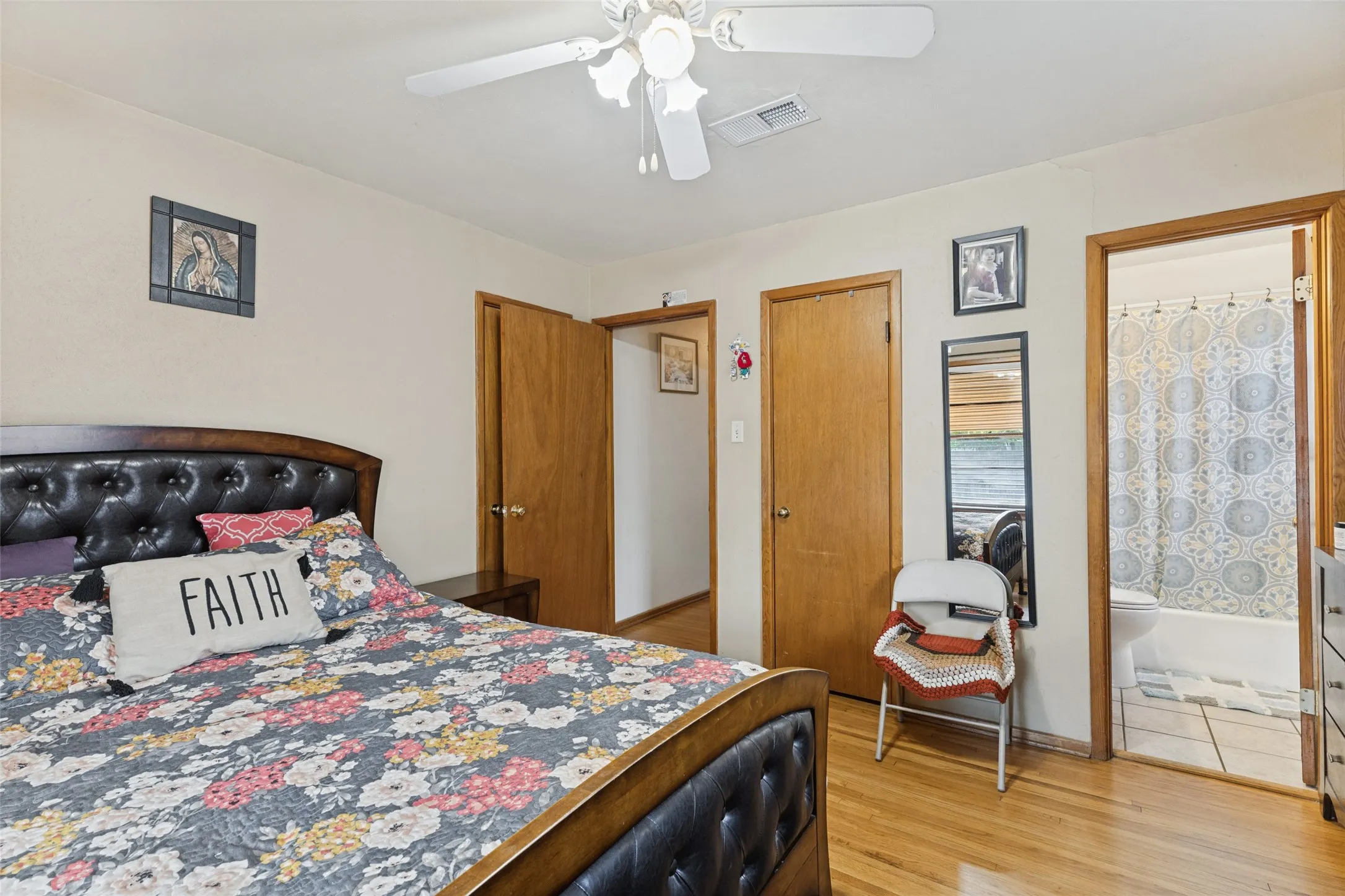 Hardwood-finish flooring, ceiling fan with light fixture, and solid wood interior doors