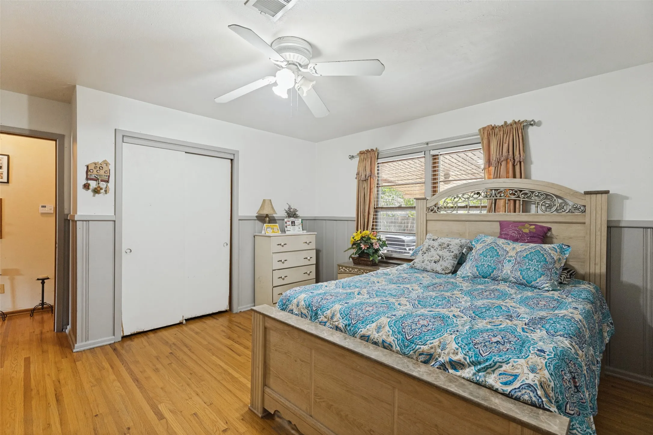 Hardwood flooring, ceiling fan, and wainscoting