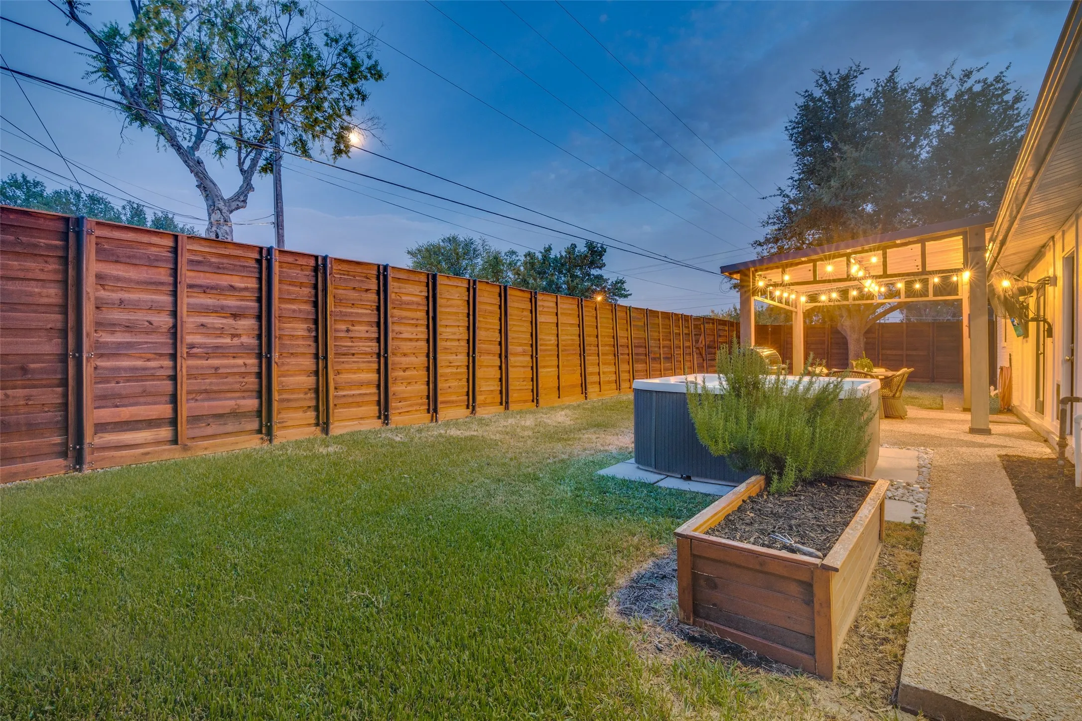 Installed in 2021, the 8 foot, horizontal plank privacy fence includes wood-wrapped metal support poles set in concrete.  This portion of the fence is situated on a retaining wall built on the back property line - also in 2021- which includes a back gate with stairs down to the alley behind.