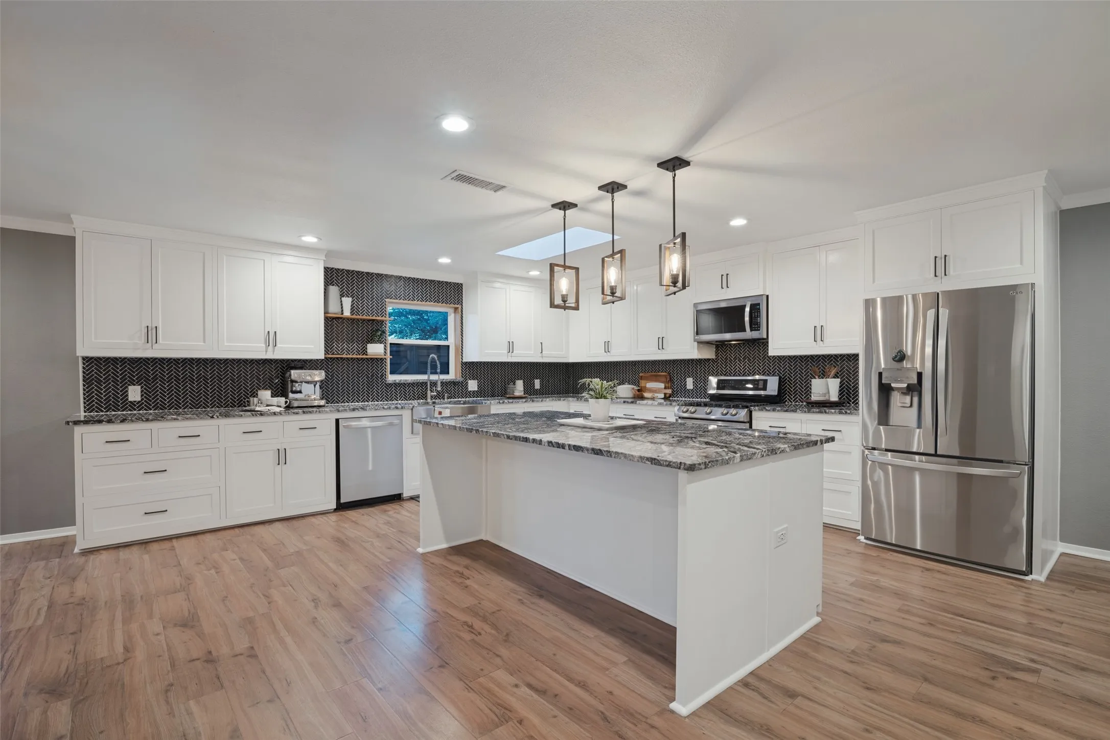 In addition to prep space, the oversized island can accomodate counter-height seating for four.