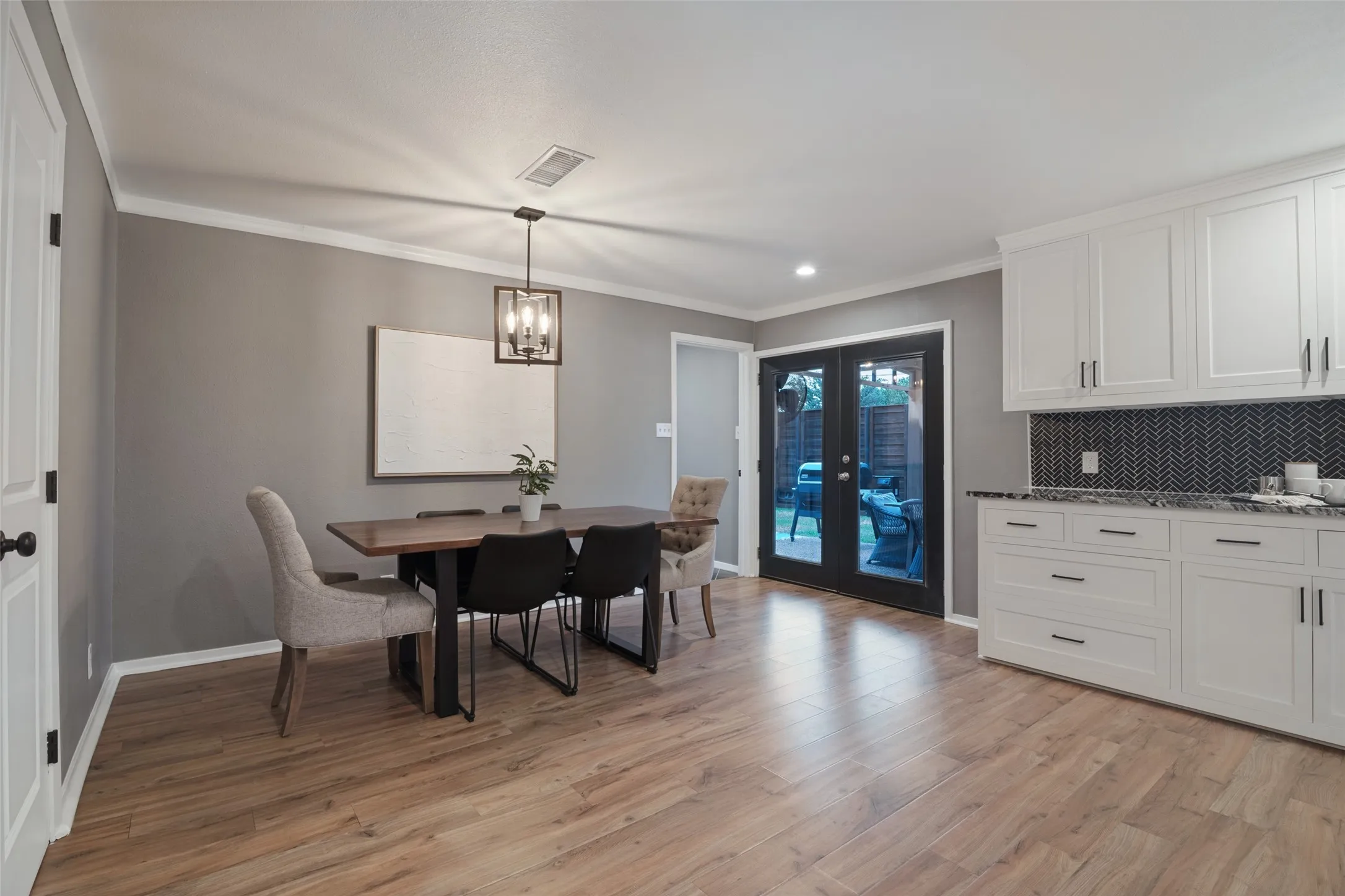 The door to the left opens to the conveniently located pantry and double French doors on the right open to the covered patio.