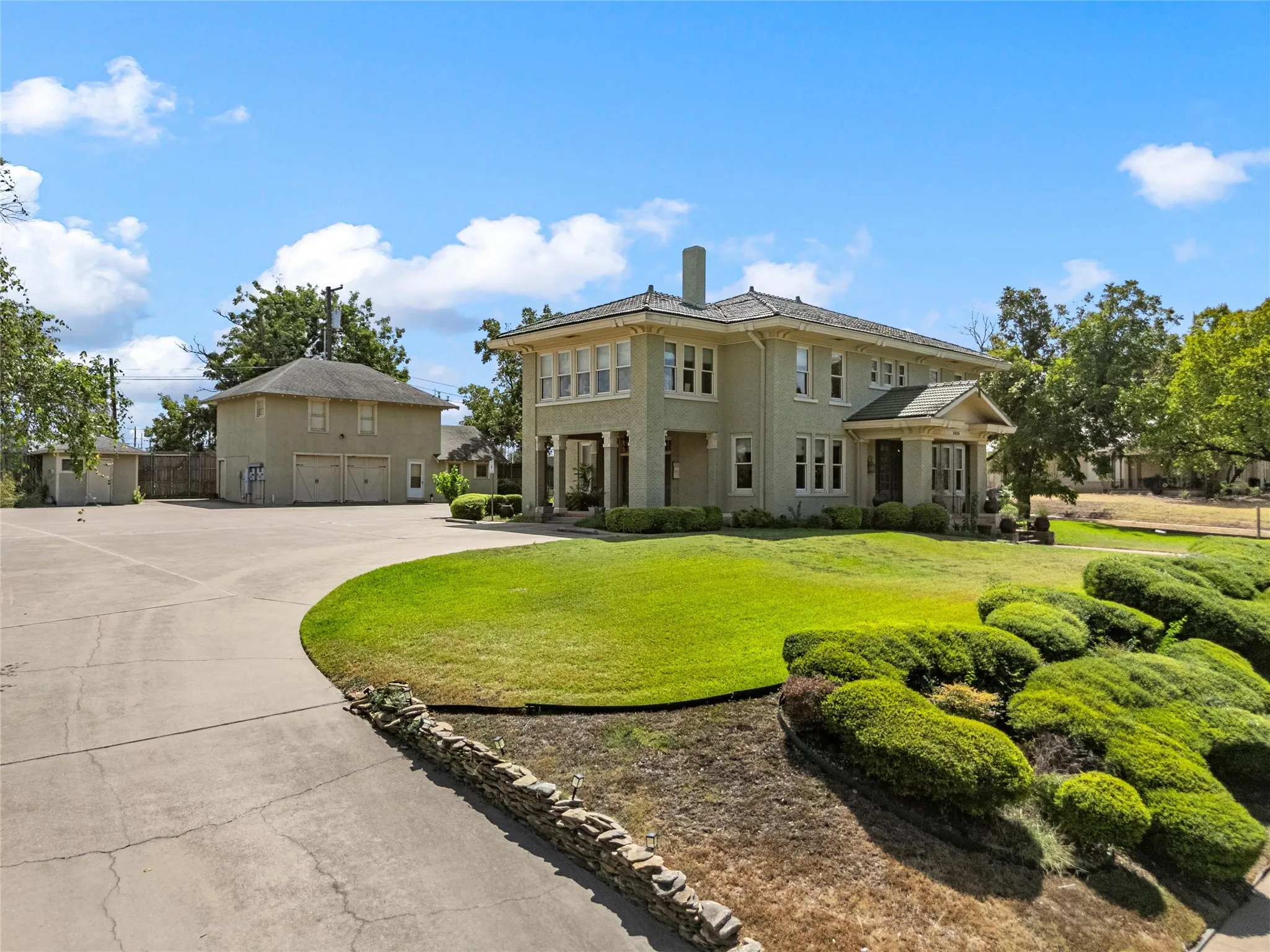 Two-story main residence with a full-width covered porch