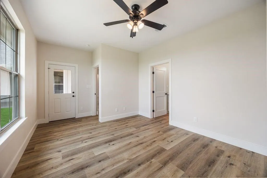 Guest bedroom with the door to the back patio