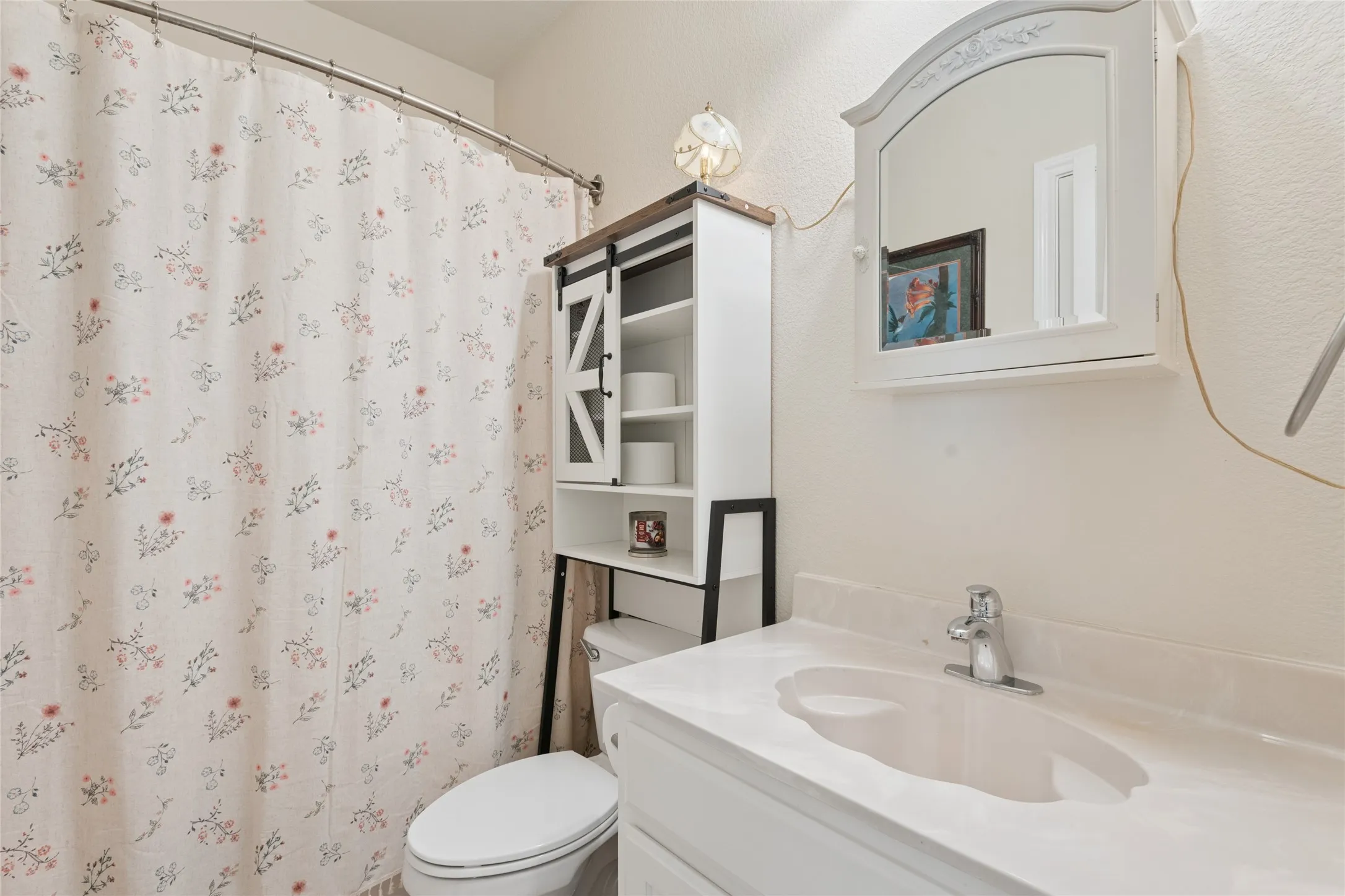 White vanity with an integrated sink and chrome faucet