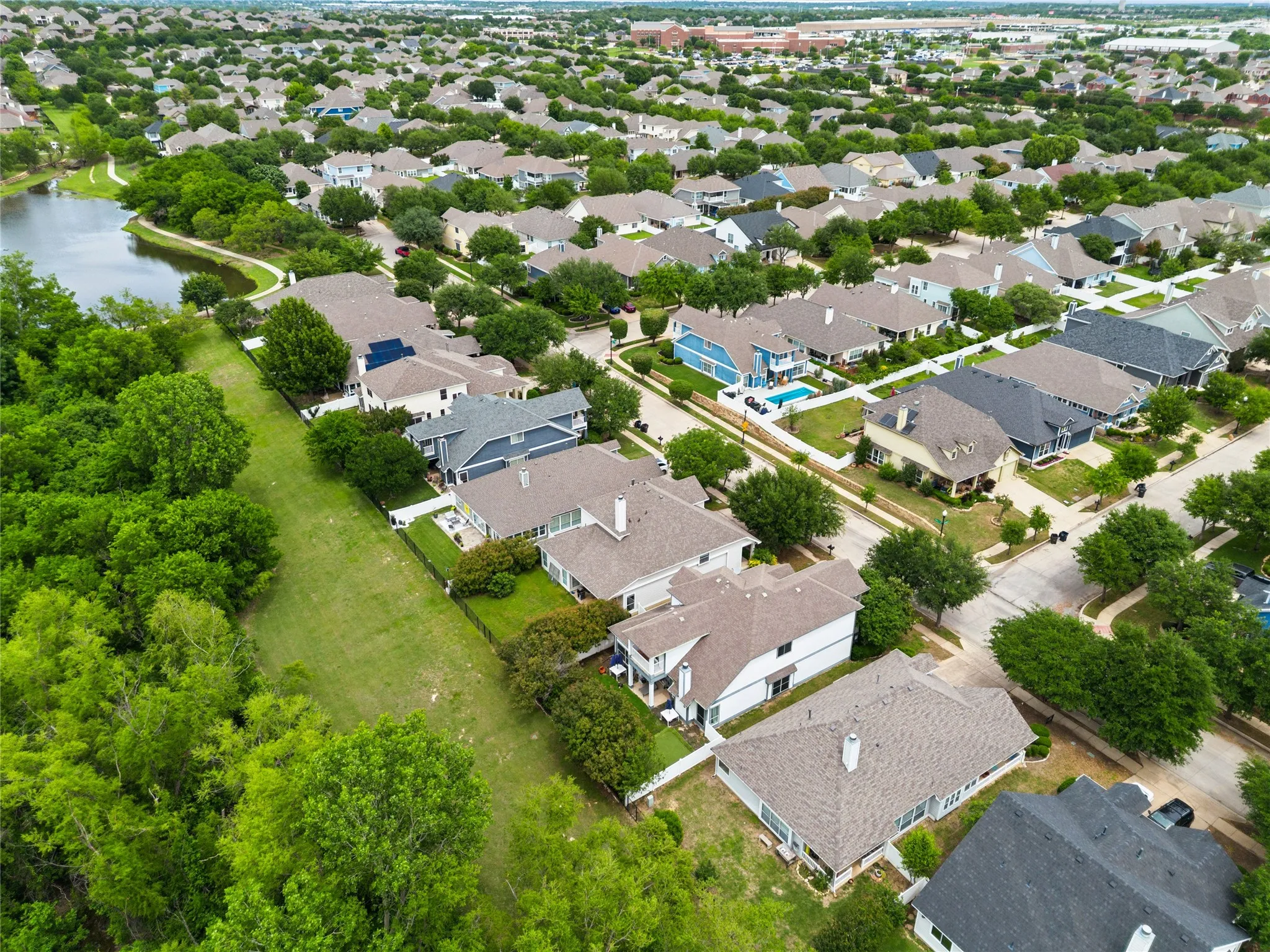 Aerial neighborhood perspective with established homes and mature trees