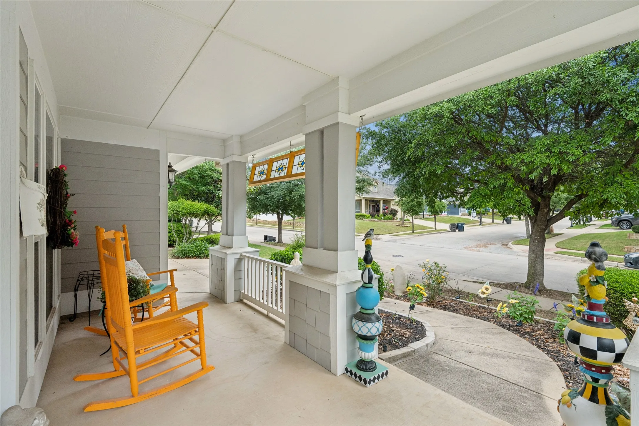 Covered porch with concrete flooring and grey horizontal siding