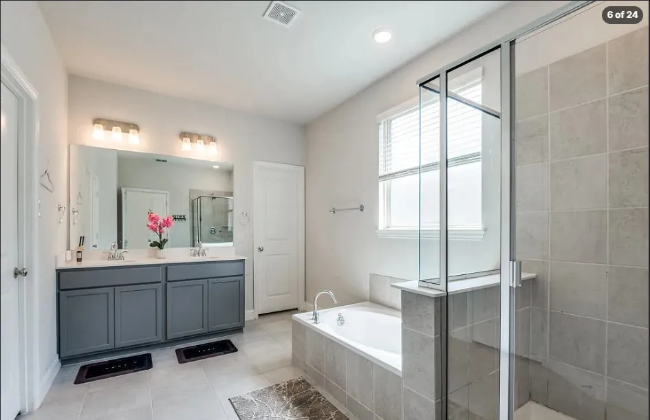 Dual vanity with gray cabinetry and white countertops