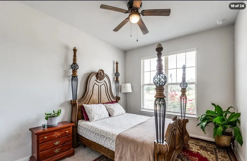 Recessed window with horizontal blinds, overhead ceiling fan with integrated lighting, and light-toned wall finishes