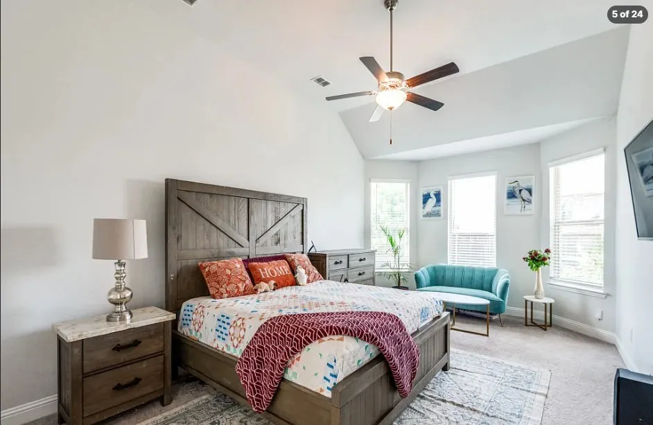 Vaulted ceiling, ceiling fan, carpet flooring, multiple windows, and recessed lighting