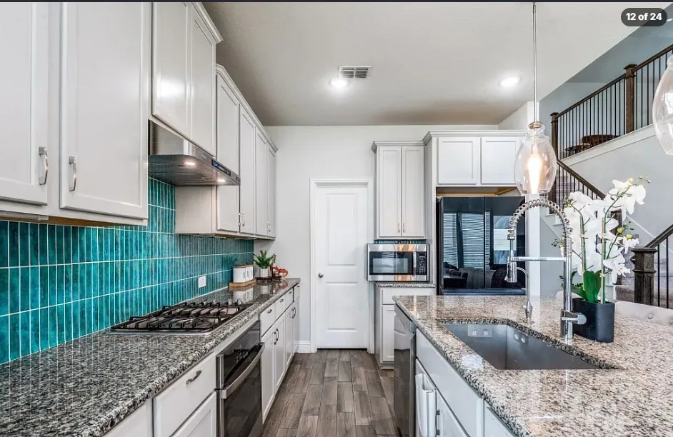 Kitchen featuring white cabinetry, a teal tile backsplash, granite countertops, a gas cooktop, and wood-finish flooring