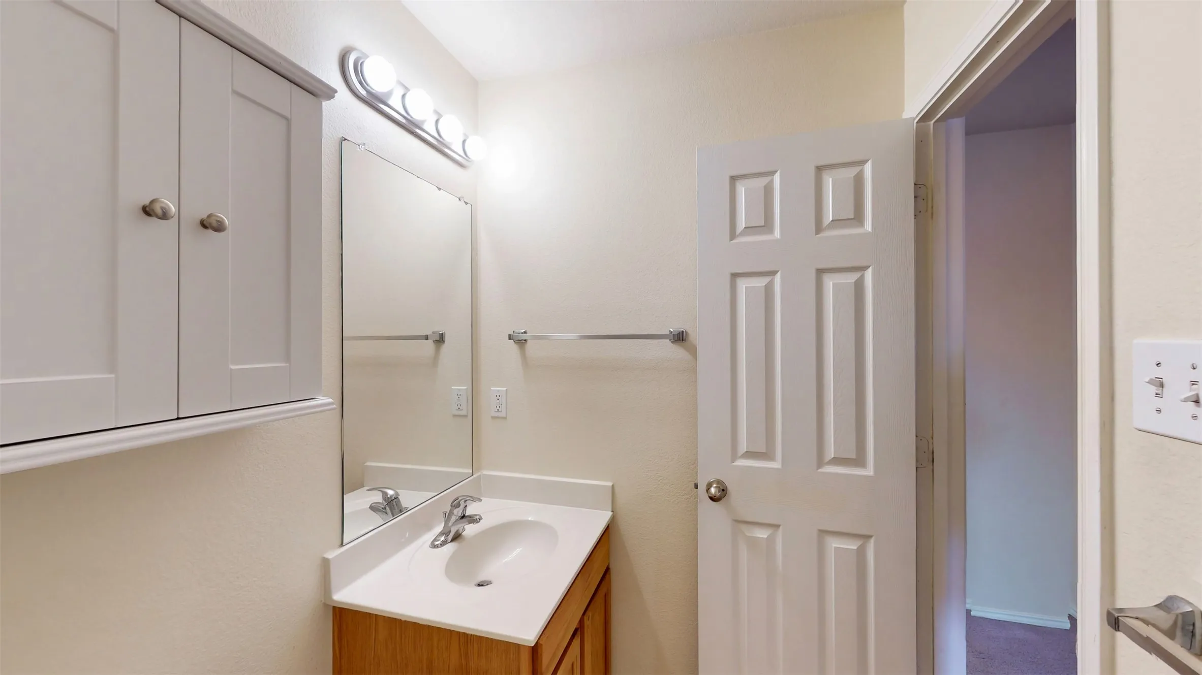 Hall bathroom equipped with built-in storage solutions.